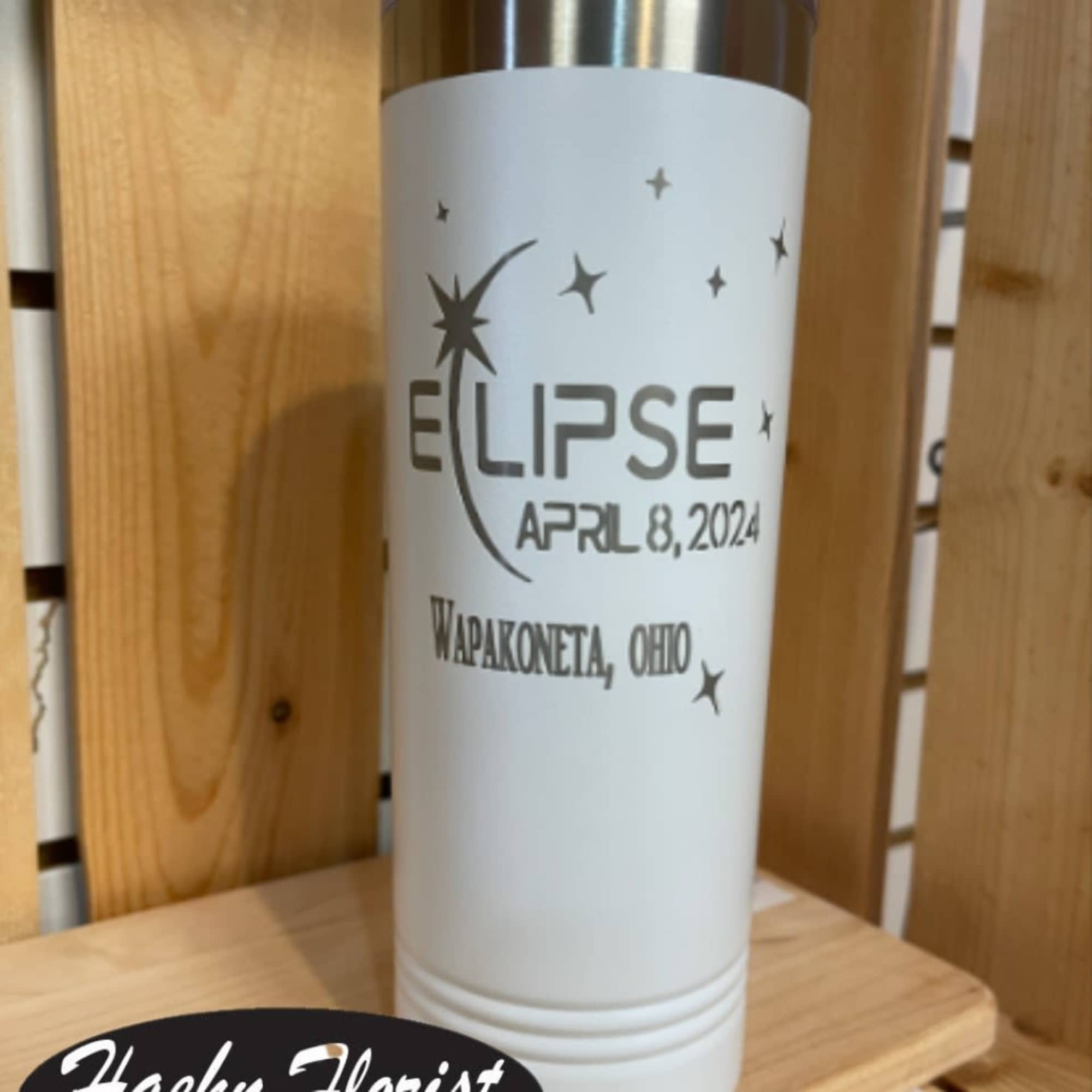 White insulated tumbler with eclipse text and stars