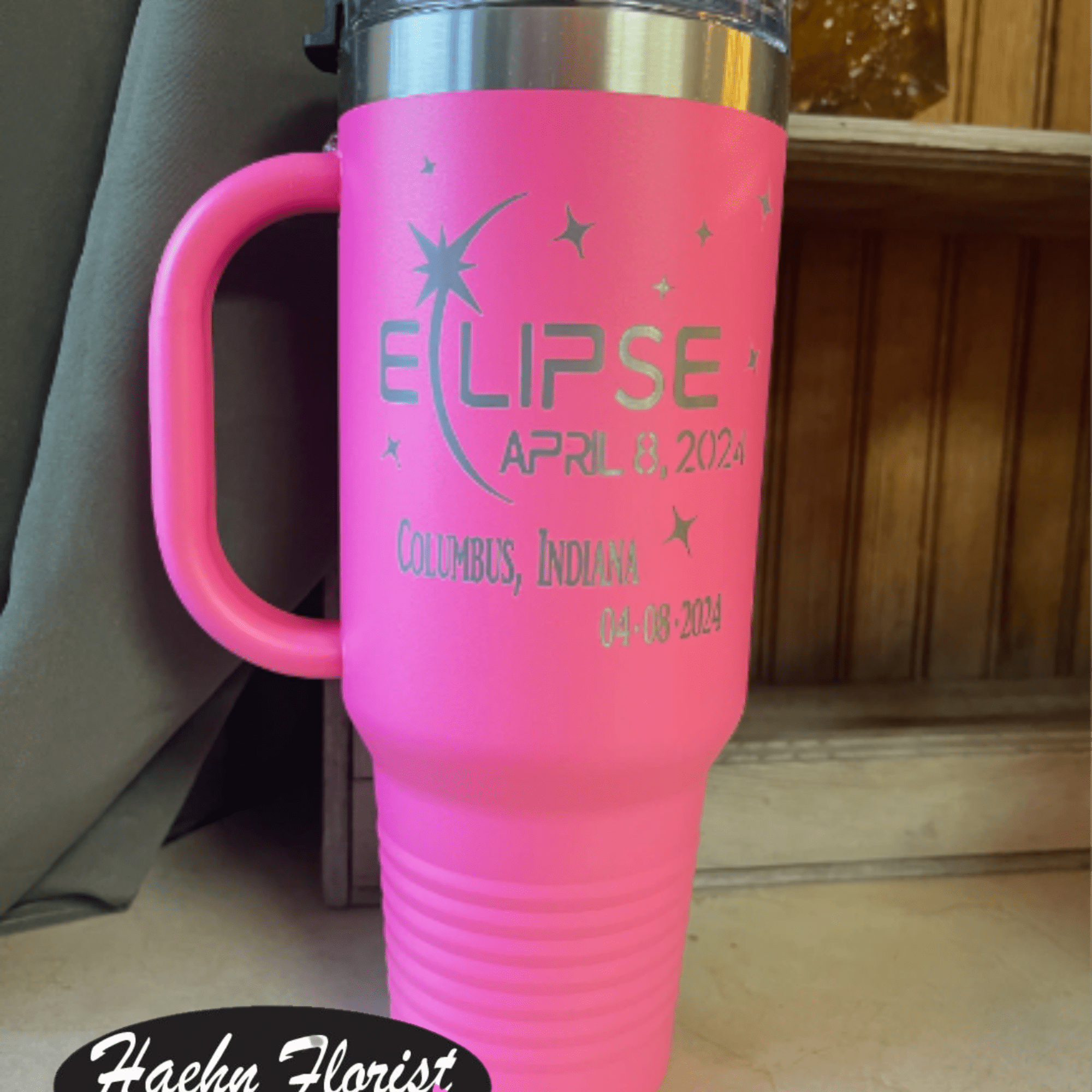 Pink insulated tumbler with a handle and eclipse text