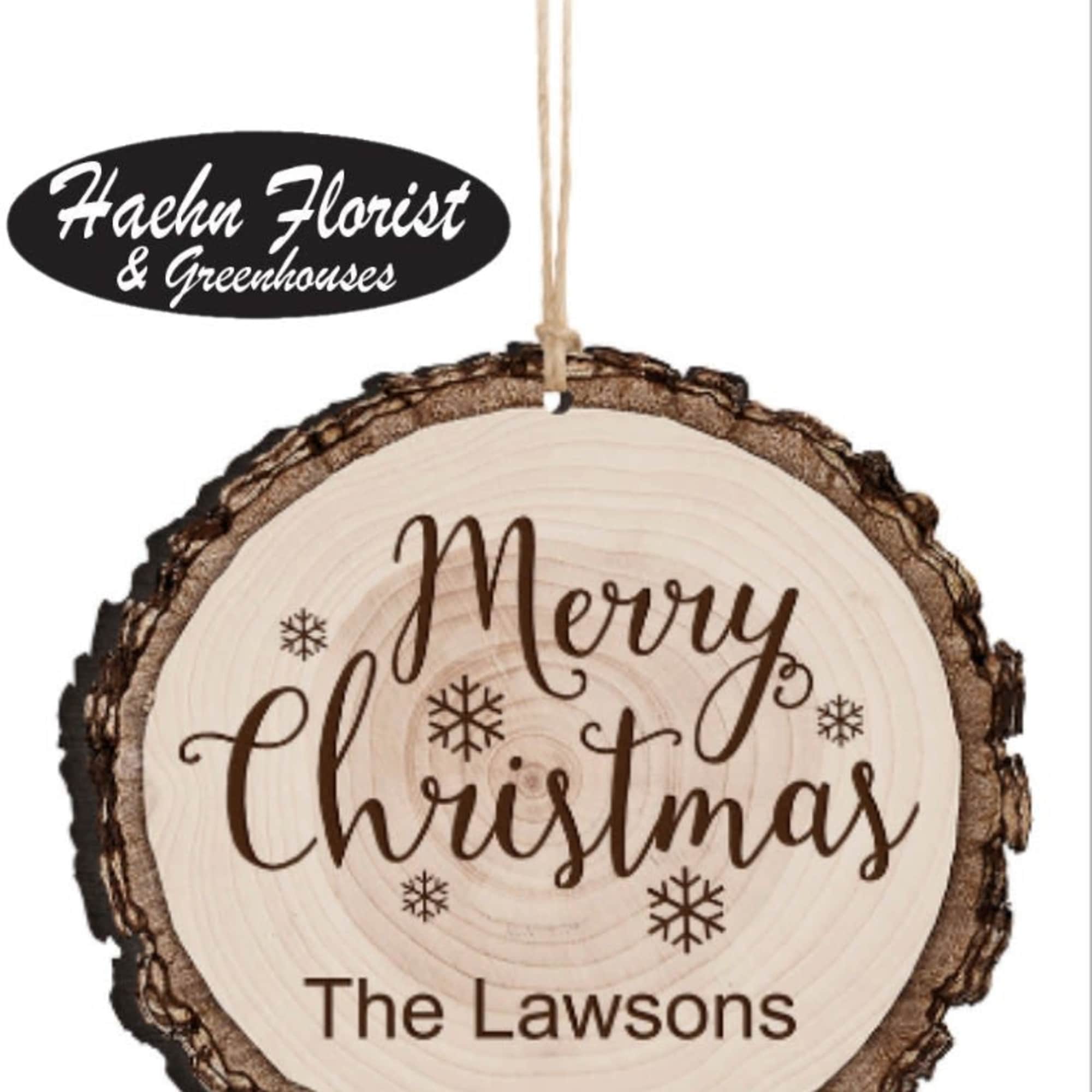 Round wooden Christmas ornament with "Merry Christmas" text