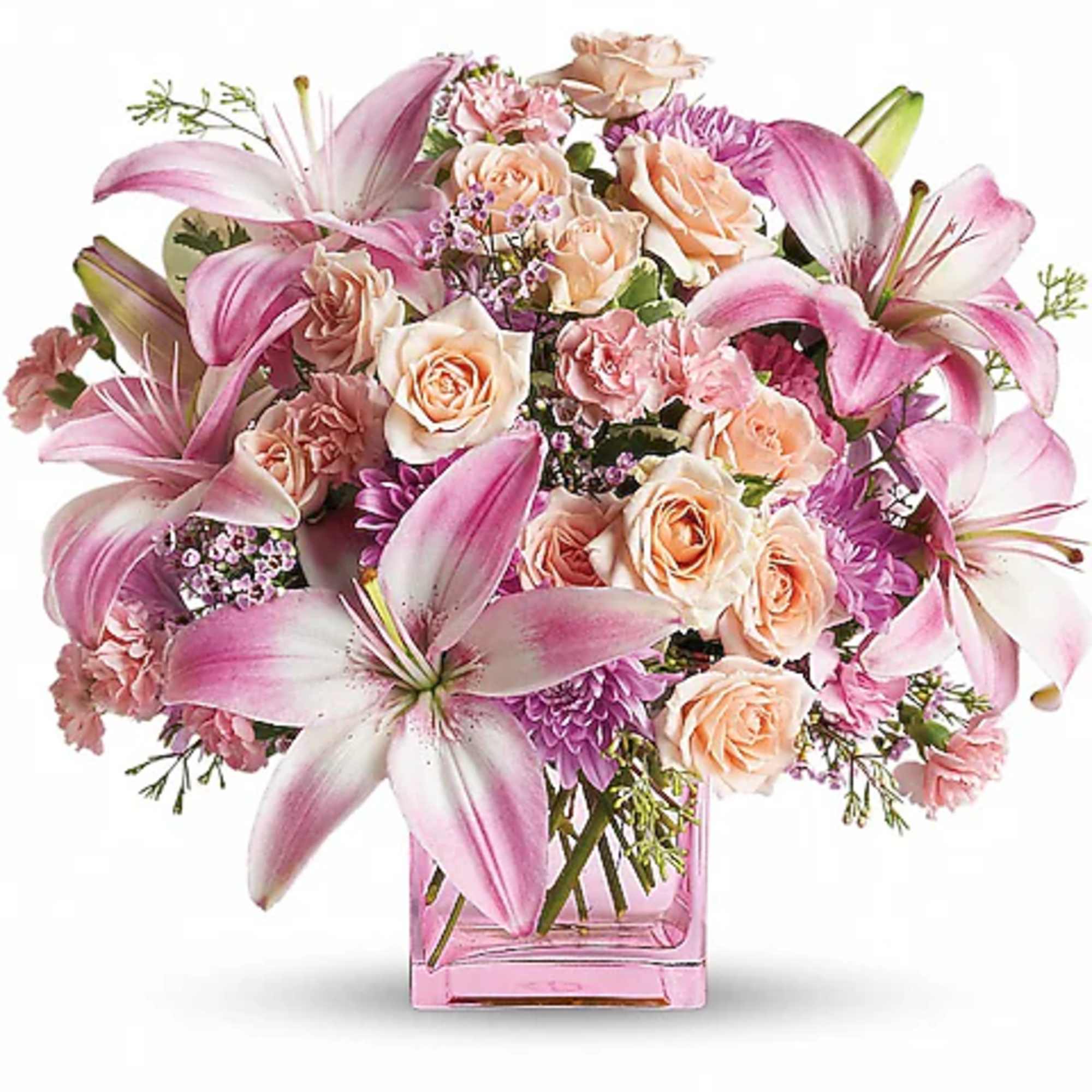 Pink lilies and peach roses arranged in a pink glass vase