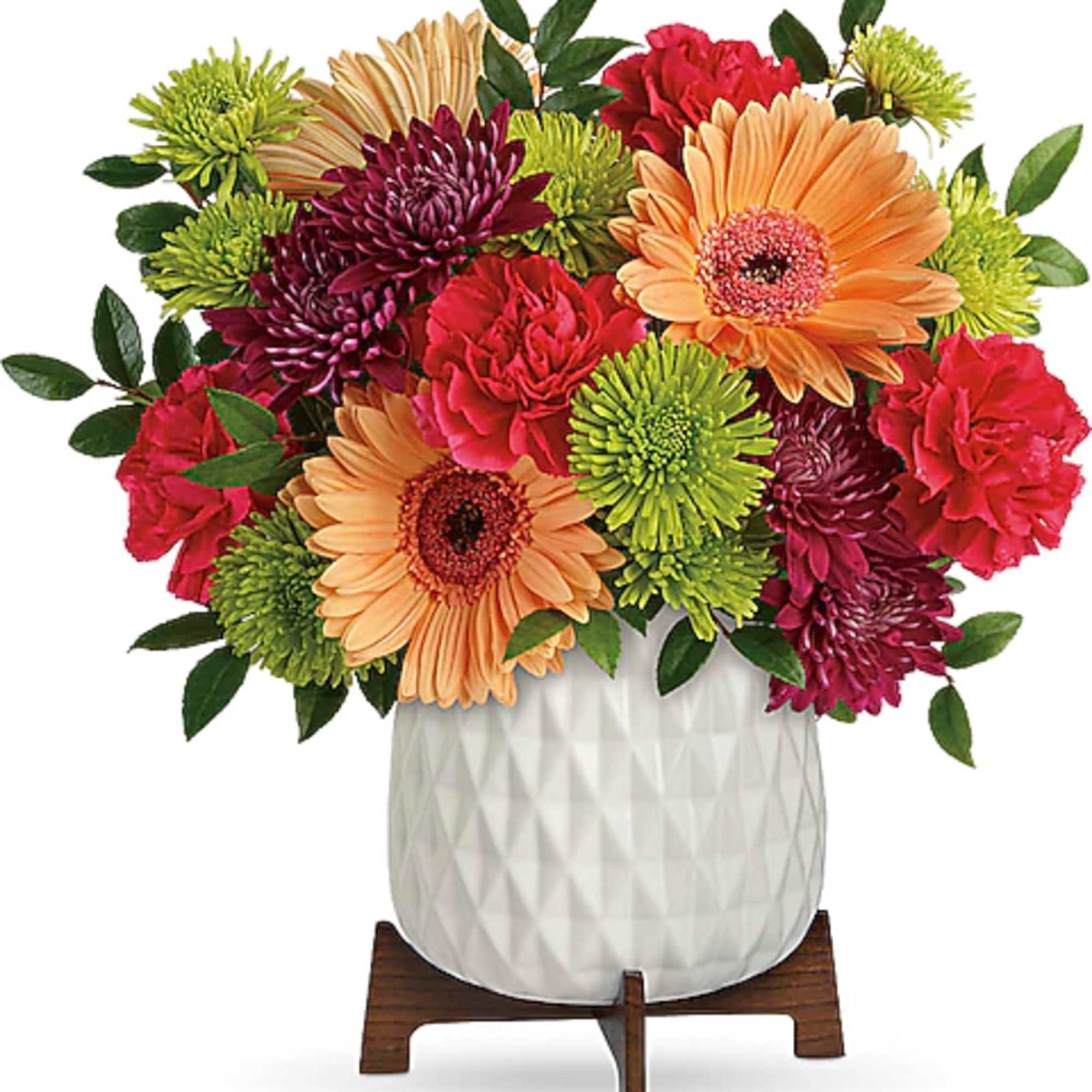 Mixed bouquet of gerbera daisies and chrysanthemums in a white vase