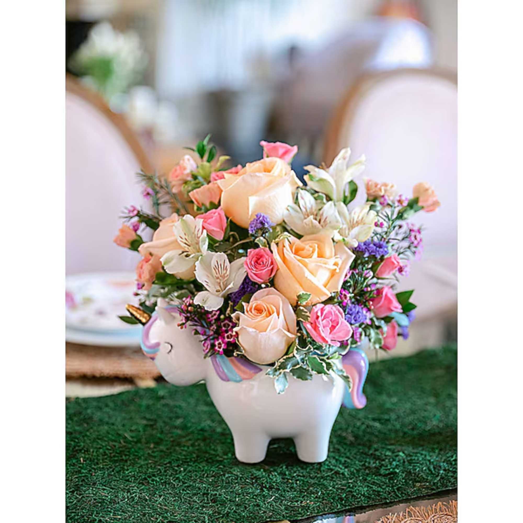 Pastel flower arrangement in a unicorn-shaped ceramic planter