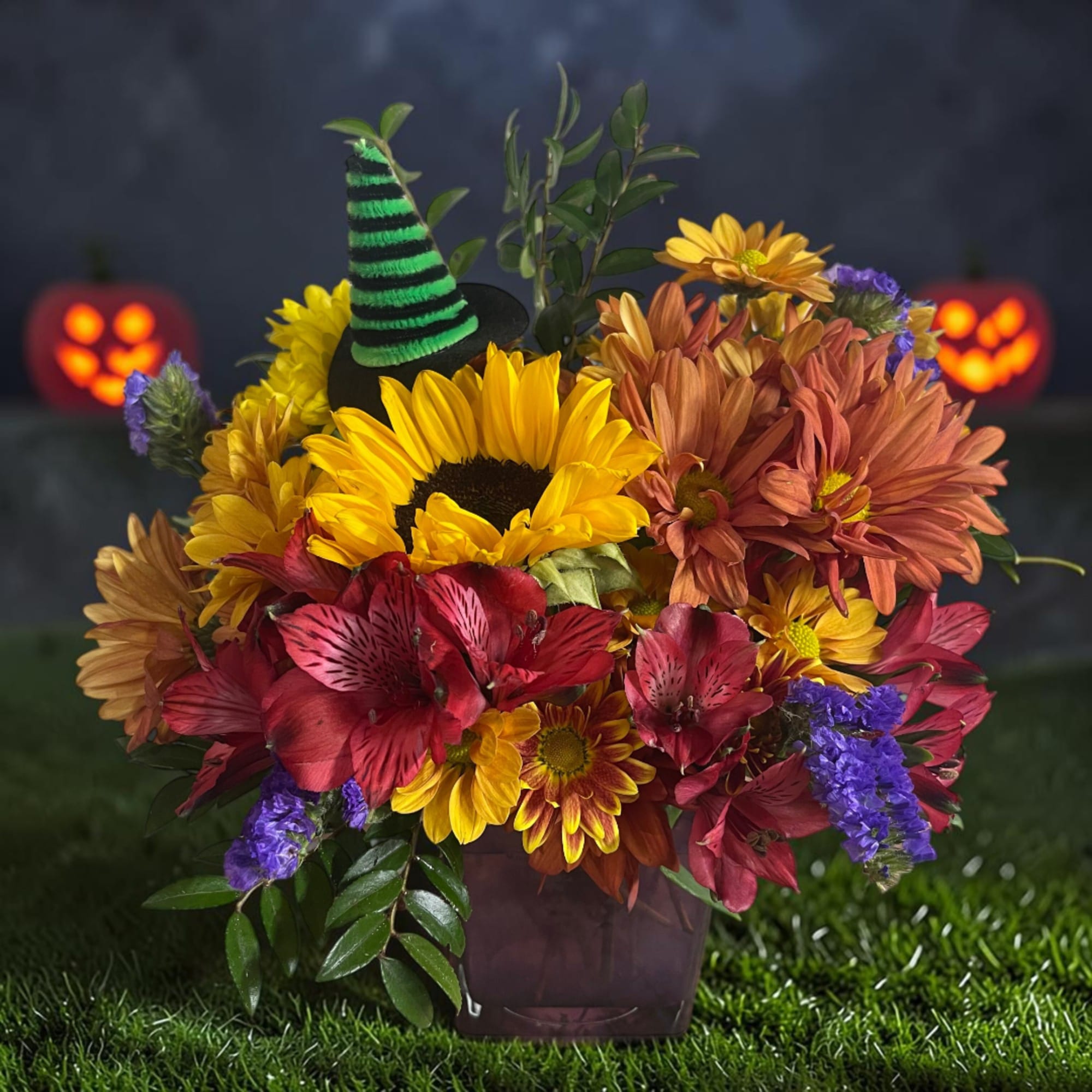 Halloween flower arrangement with sunflowers and orange mums in a vase