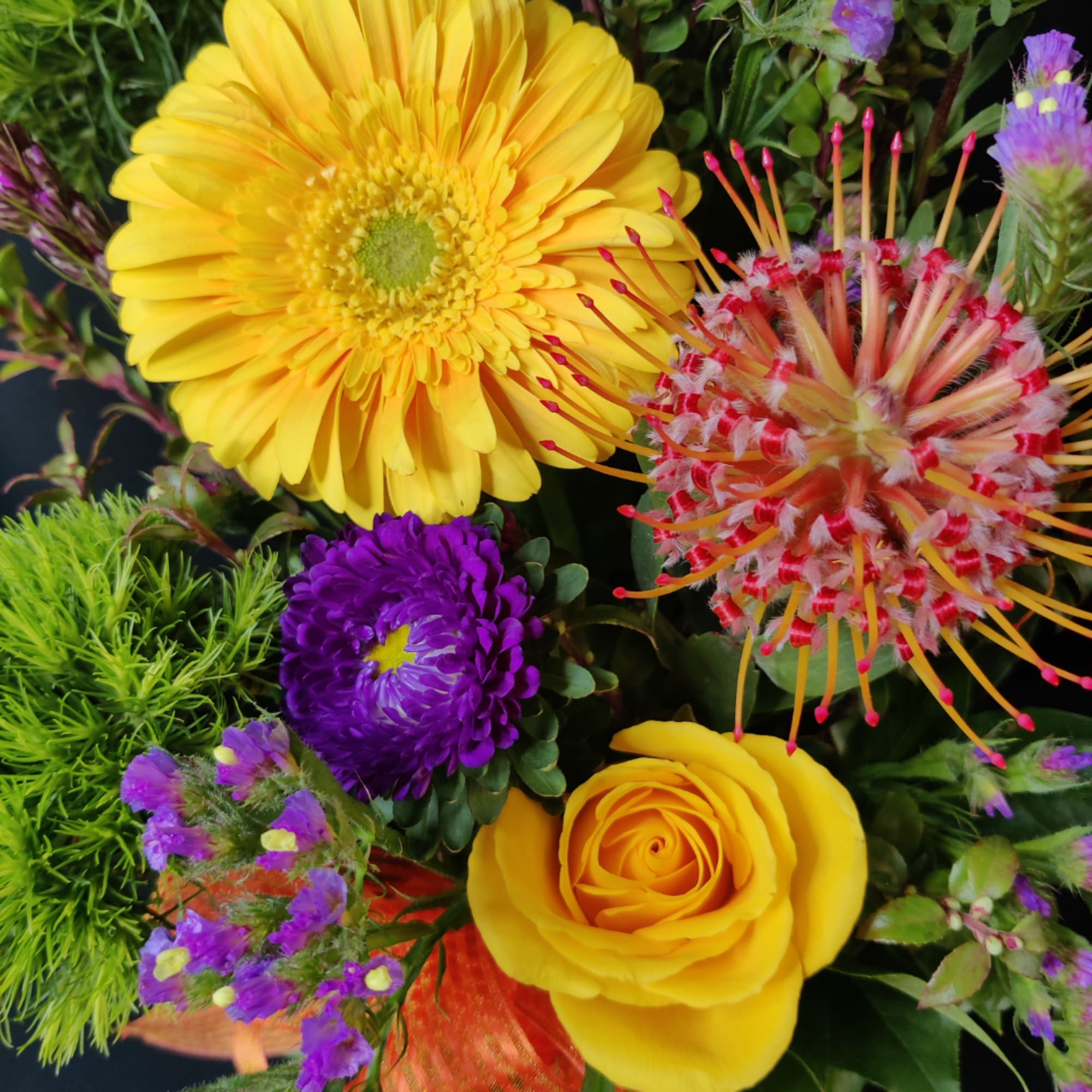Bright mixed bouquet with yellow gerbera, yellow rose, and purple blooms