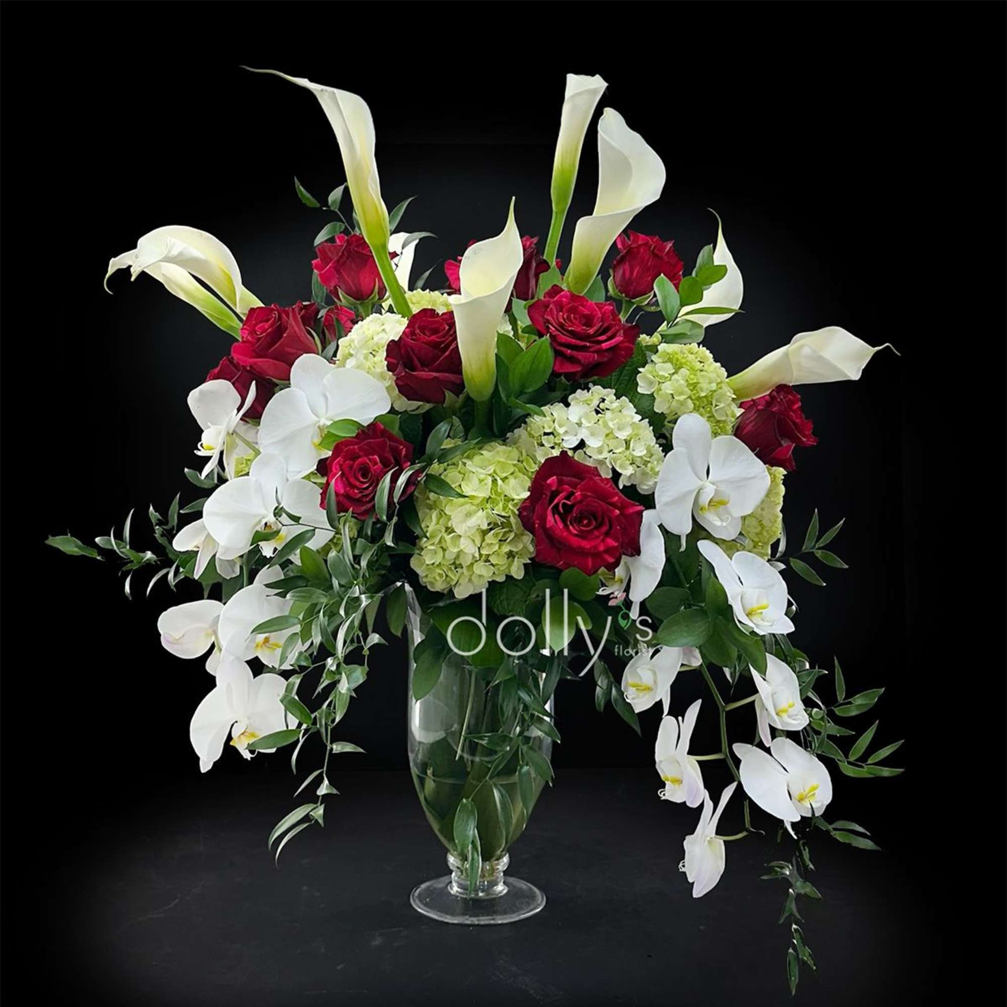 Red panther roses clustered against tall white calla lilies and cascading white, photo 2 of 2
