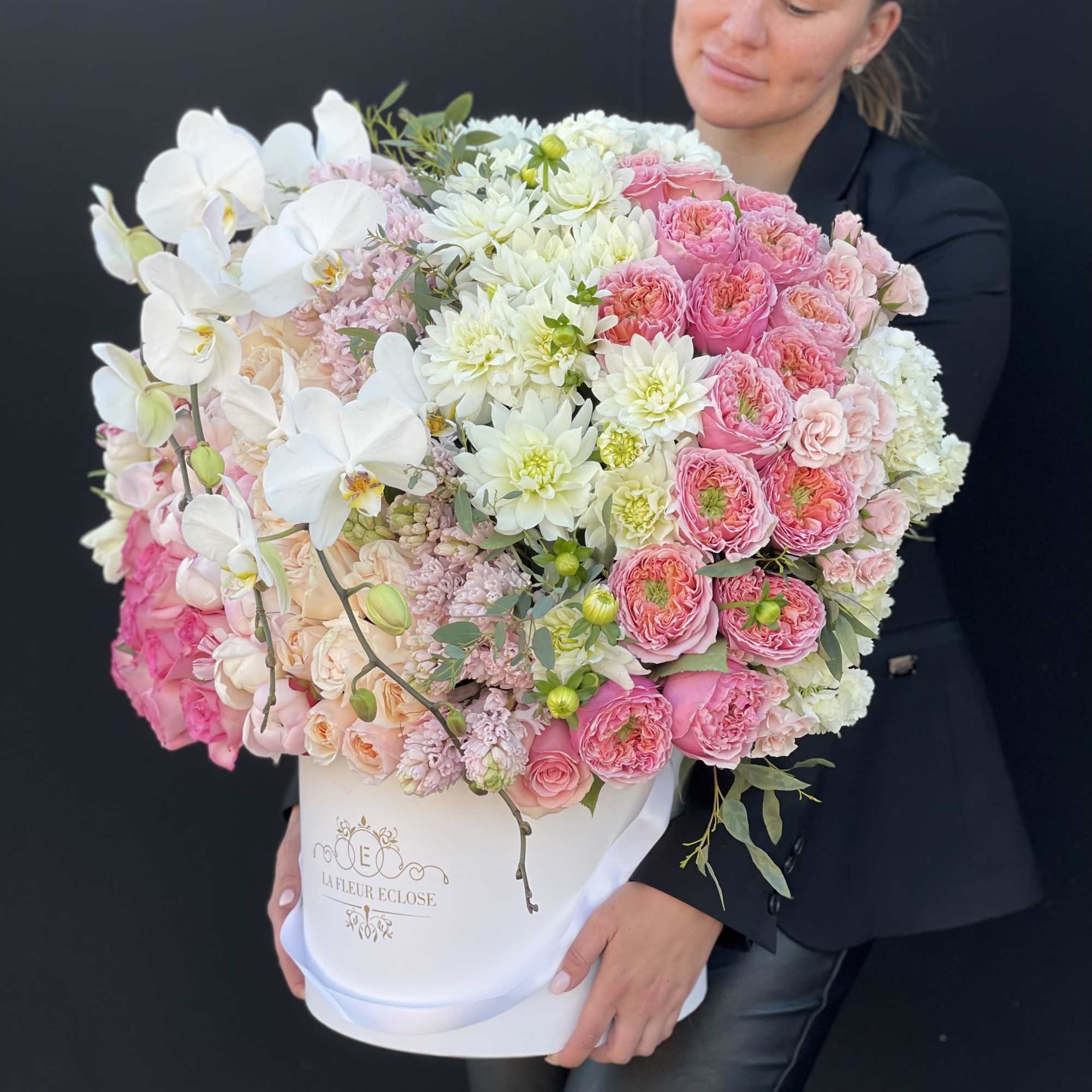 Large bouquet of pink and white flowers in a white hatbox