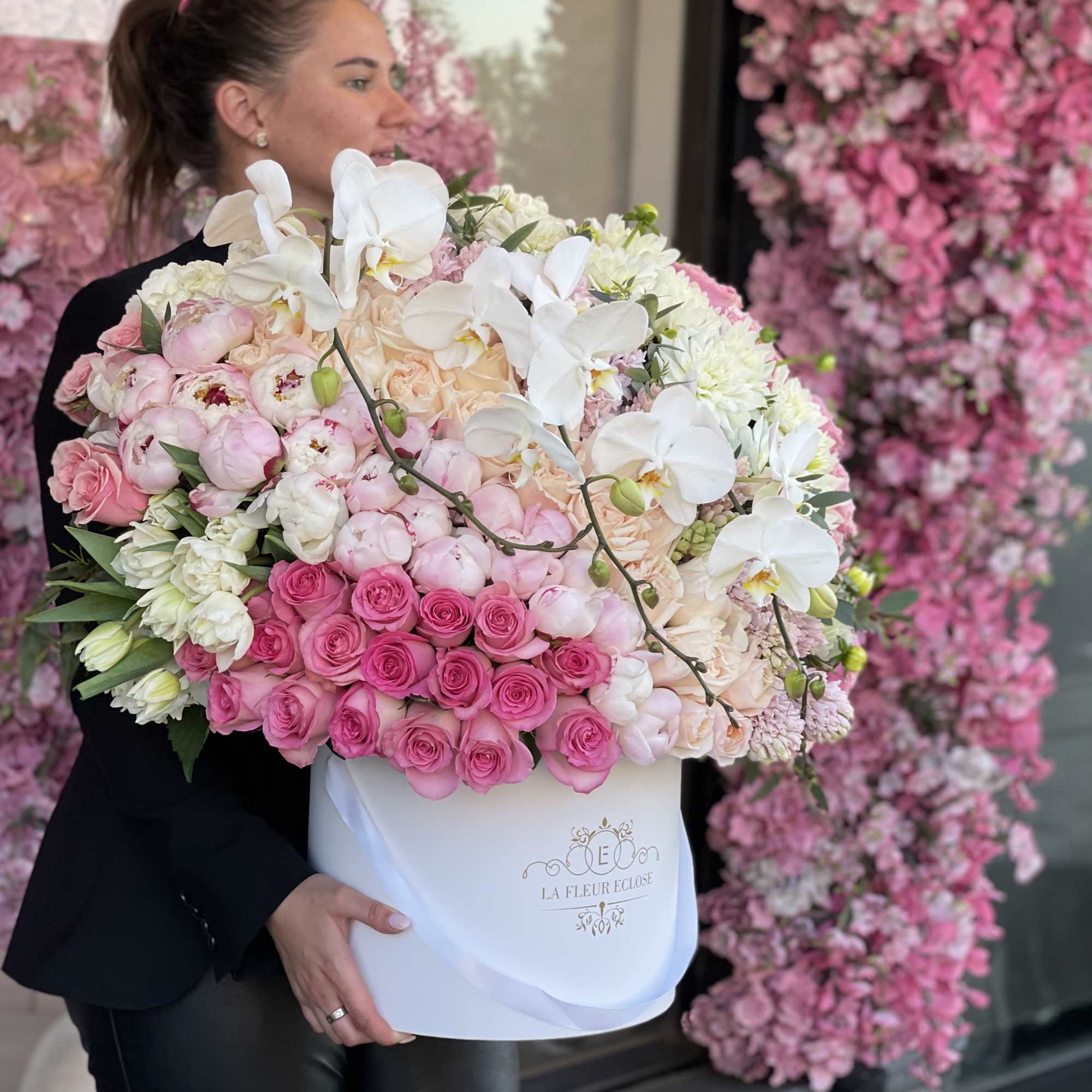 Large pink and white floral arrangement in a white hat box