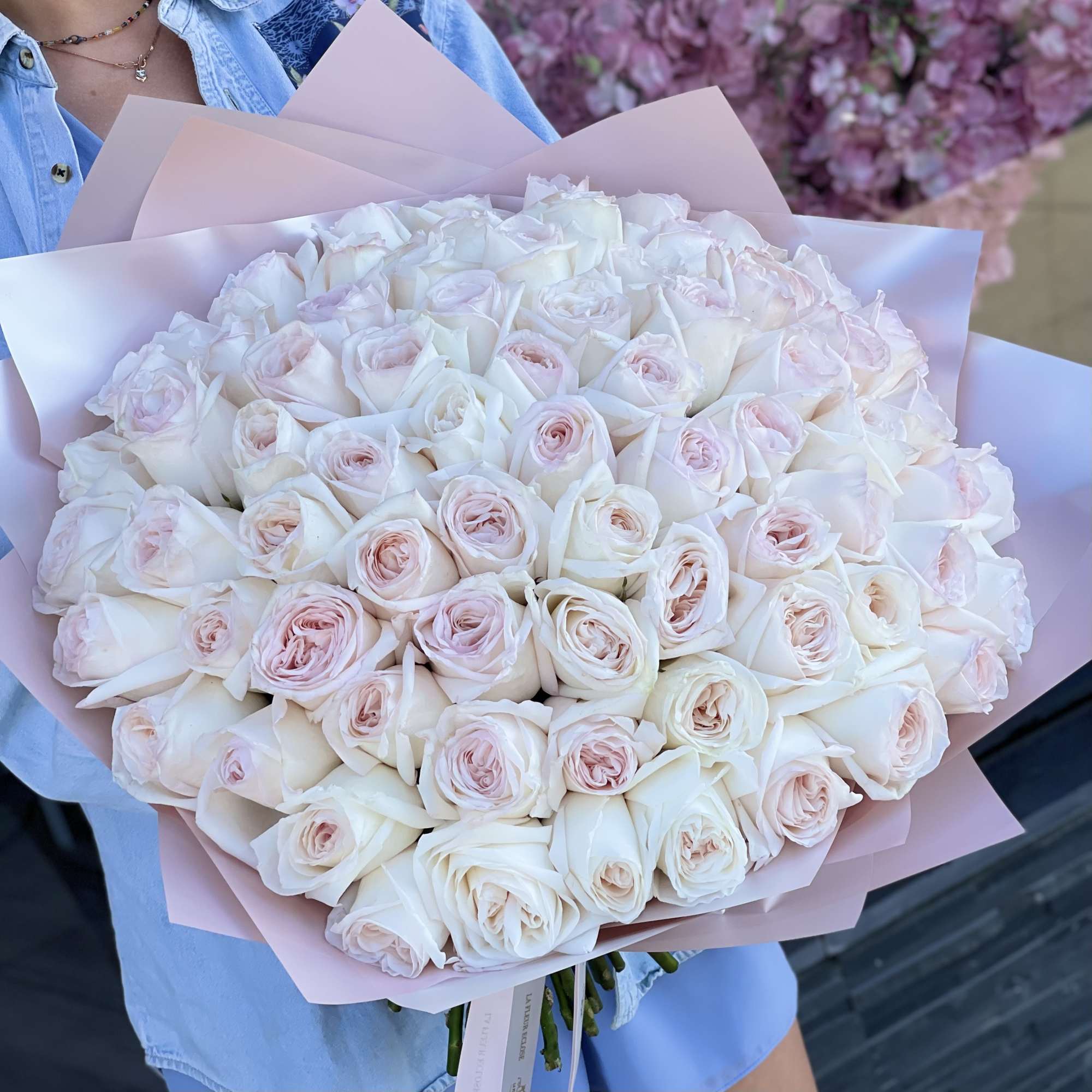 Large bouquet of pale pink and white roses wrapped in pink paper, photo 2 of 2
