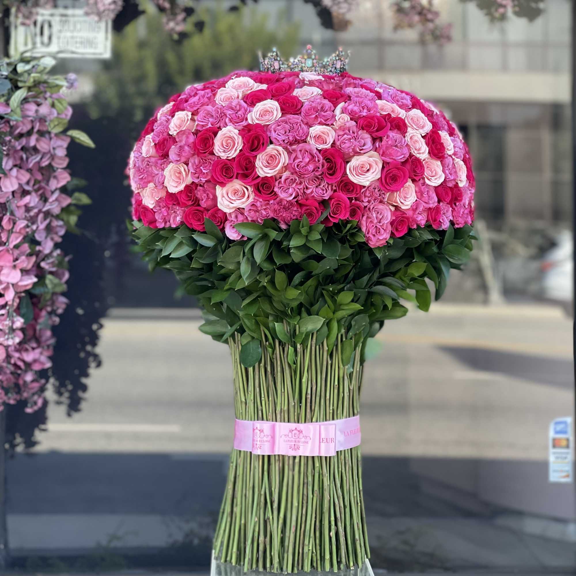 Large bouquet of pink and white roses with a tiara topper