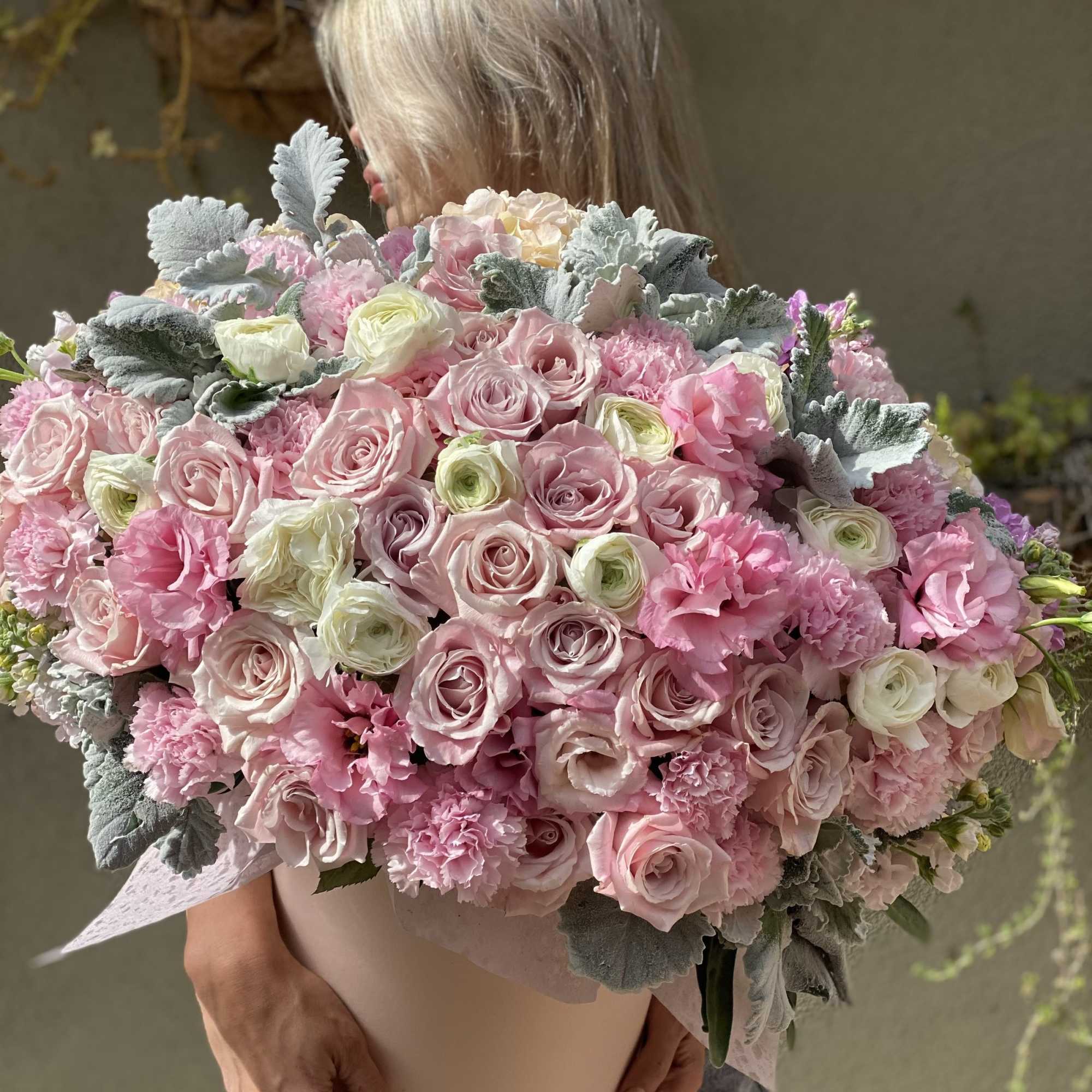 Large bouquet of pink and white roses with ruffled pink flowers