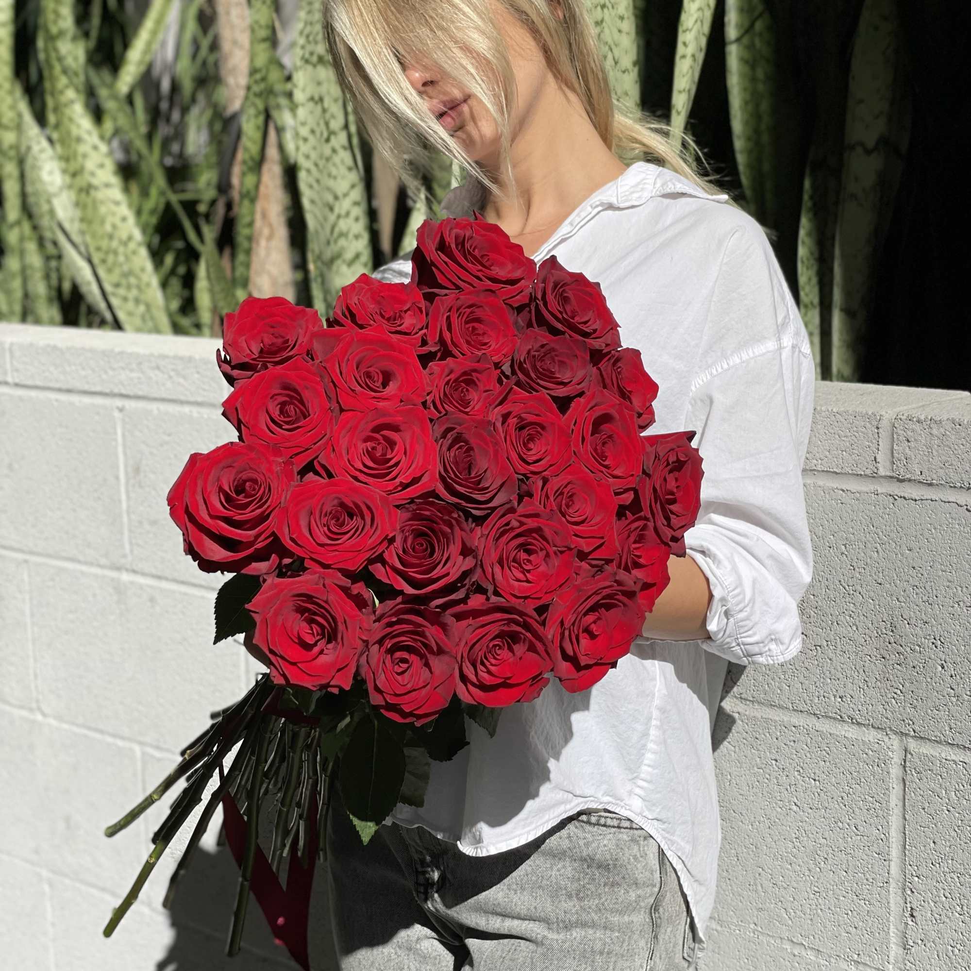 Woman holding a large bouquet of red roses, photo 15 of 15