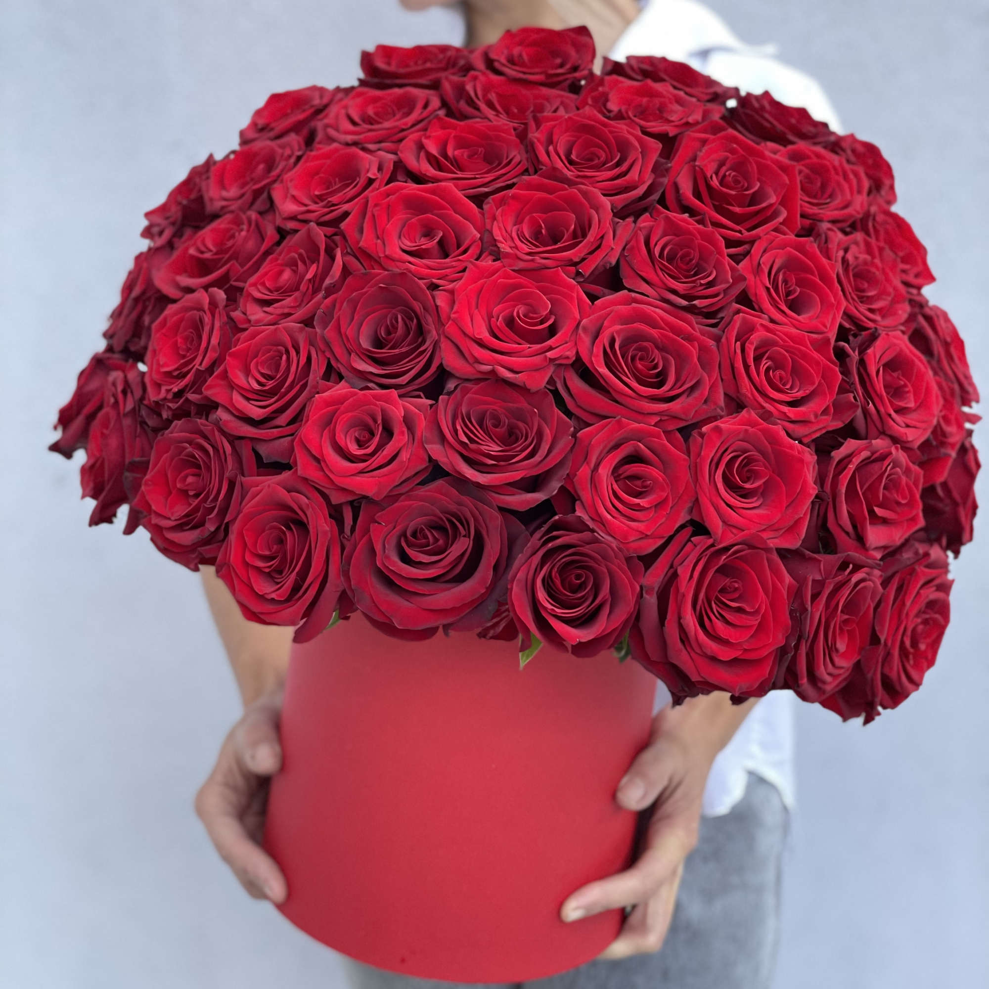 Large bouquet of red roses in a red hat box
