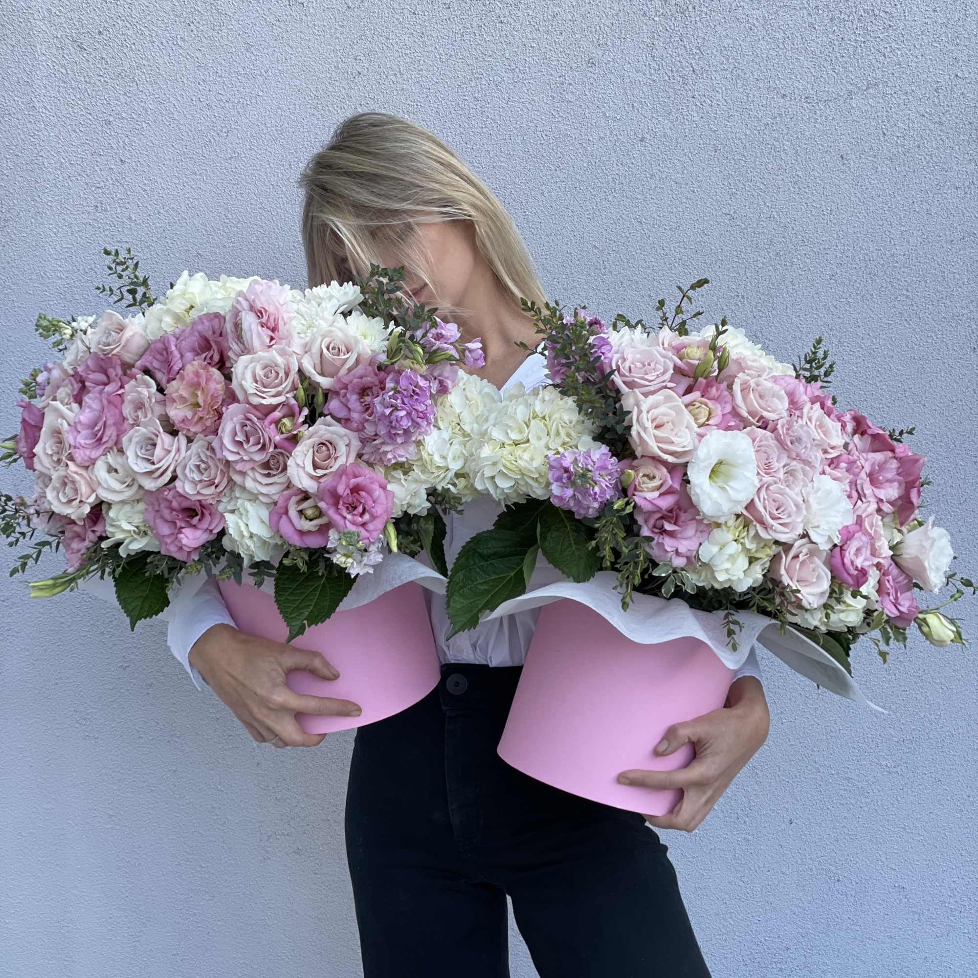 Woman holding two large pink and white flower boxes, photo 7 of 7