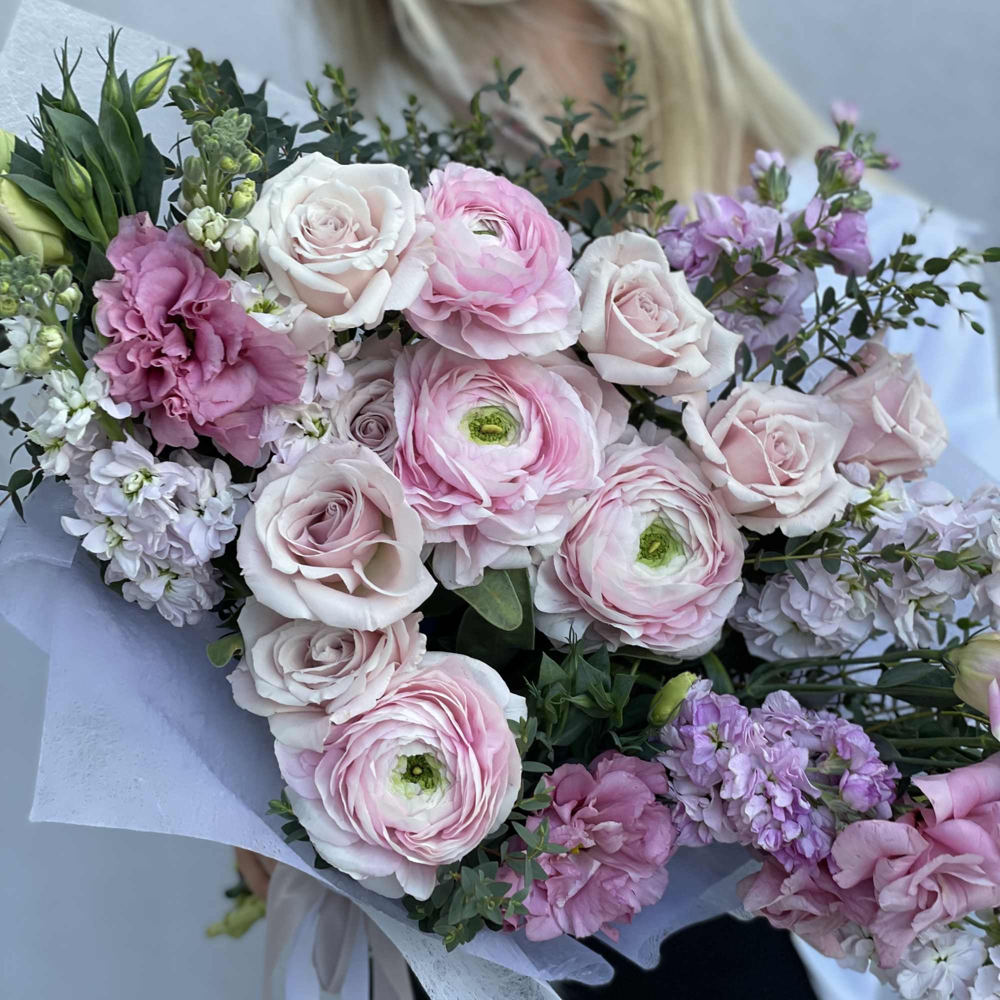 Large bouquet of pink and white roses with lavender blooms