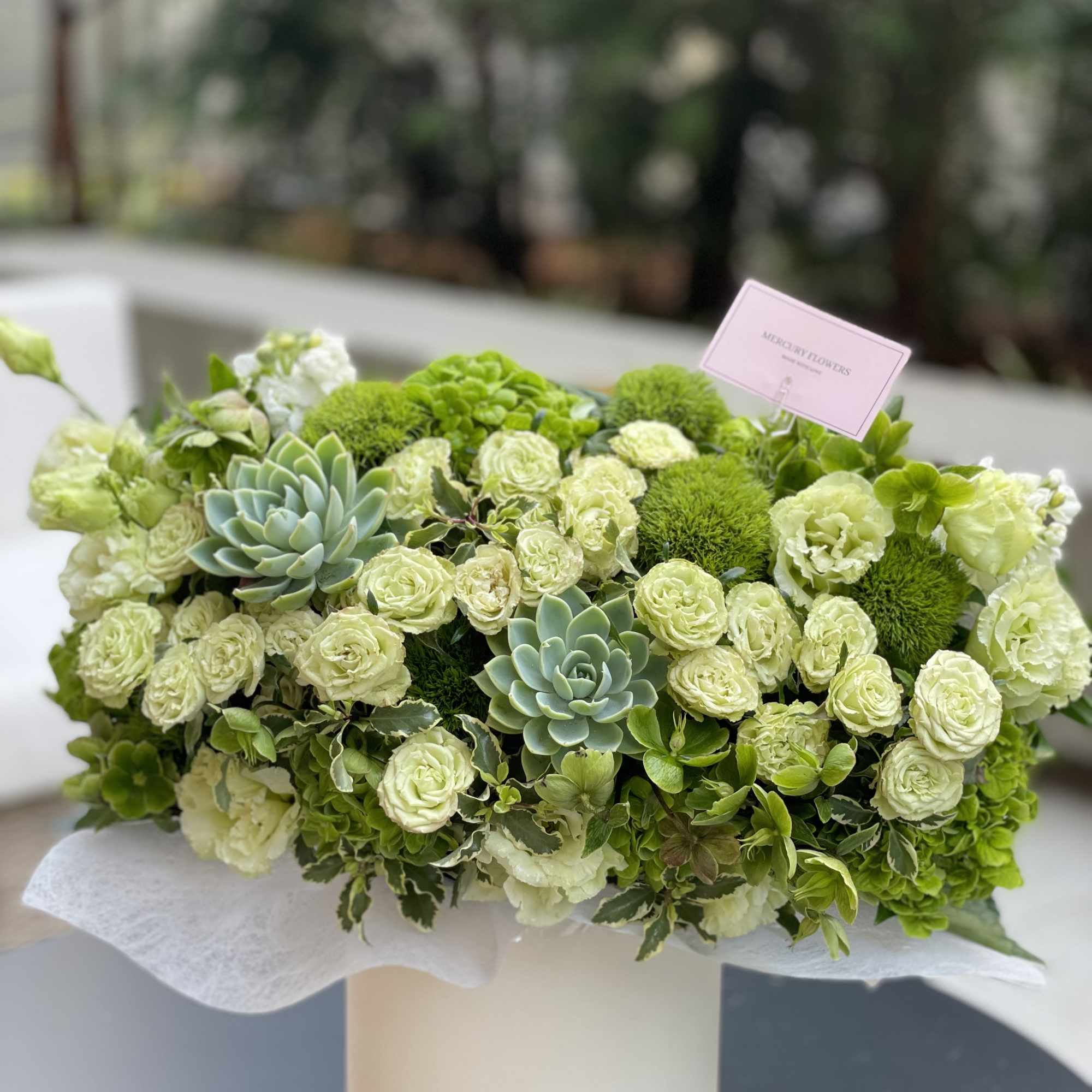 Green floral arrangement with roses and succulents in a white box, photo 6 of 10
