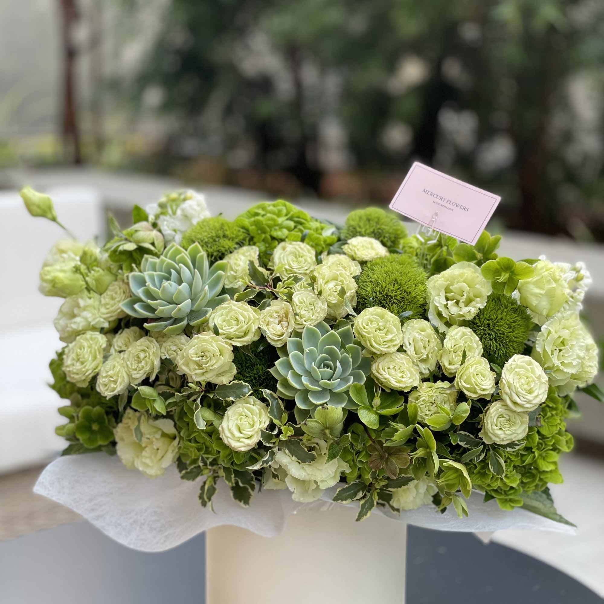 Green floral arrangement with roses and succulents in a white box, photo 10 of 10