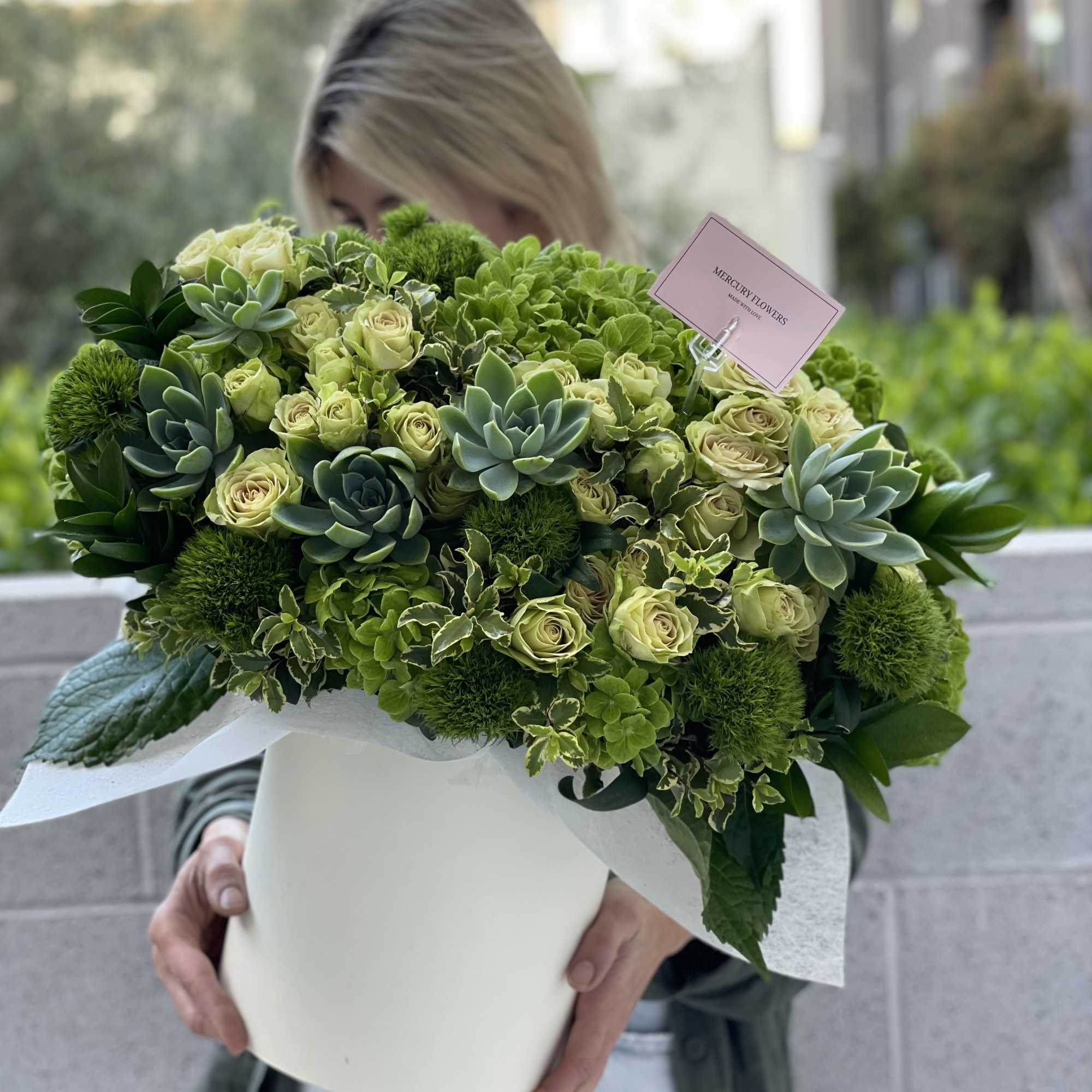 Large green bouquet with roses and succulents in a white box
