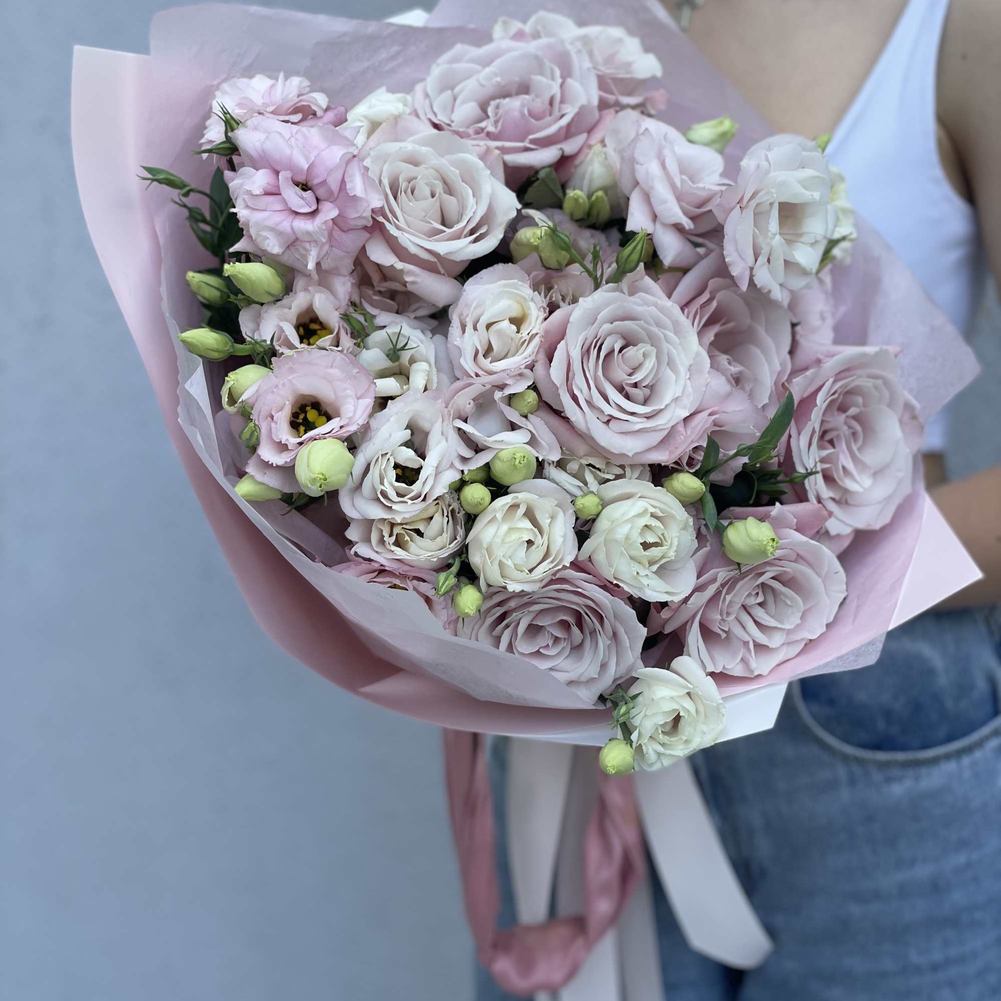 Handheld bouquet of pale pink and white roses wrapped in pink paper, photo 5 of 10