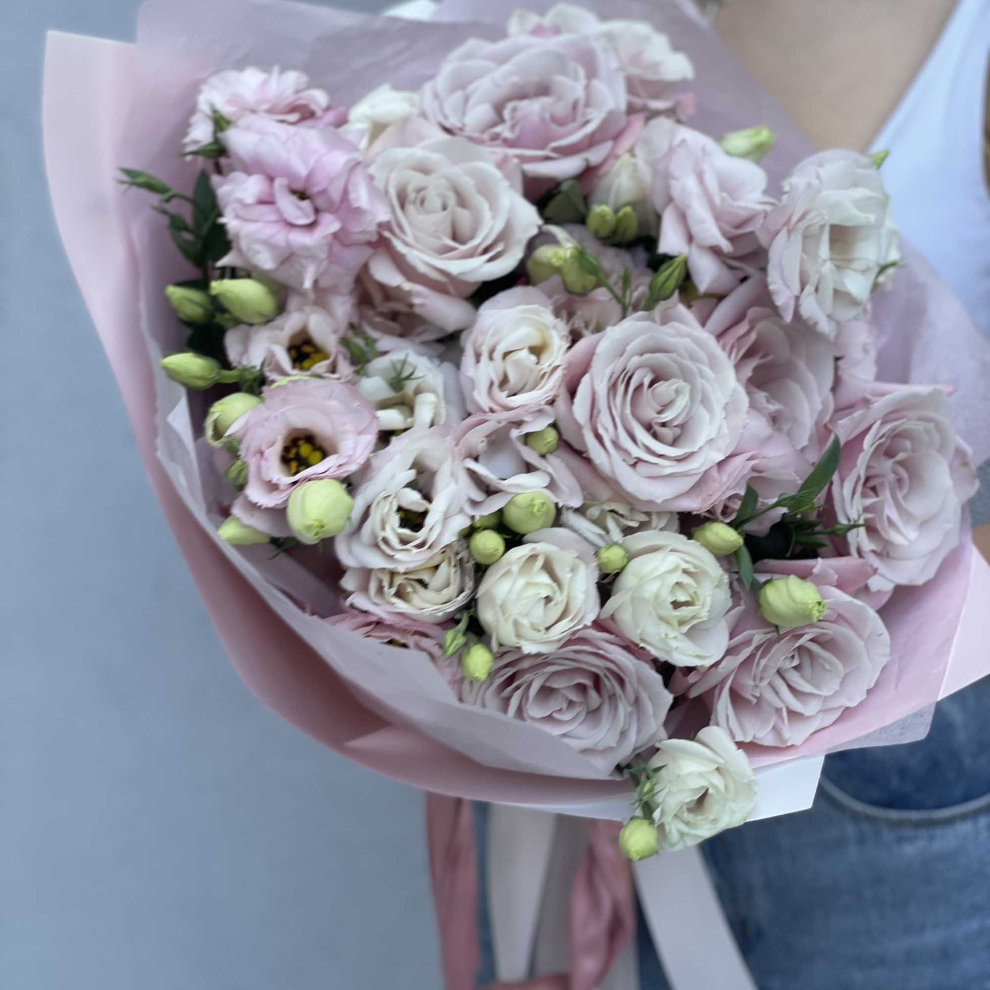 Handheld bouquet of pale pink and white roses wrapped in pink paper, photo 7 of 10
