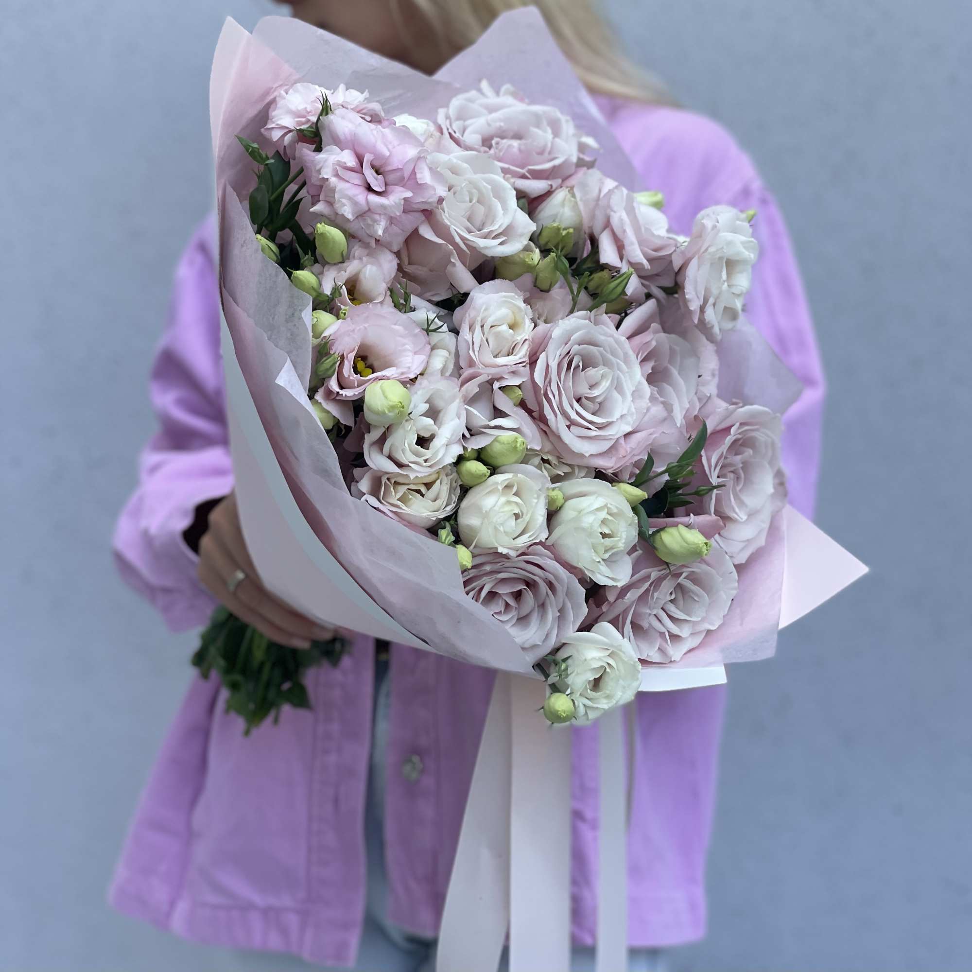 Handheld bouquet of pale pink and white roses wrapped in pink paper, photo 8 of 10