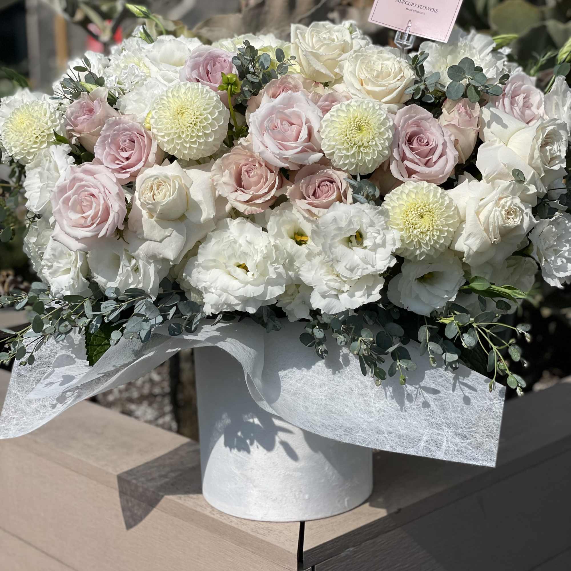 Large bouquet of white and blush roses in a white box