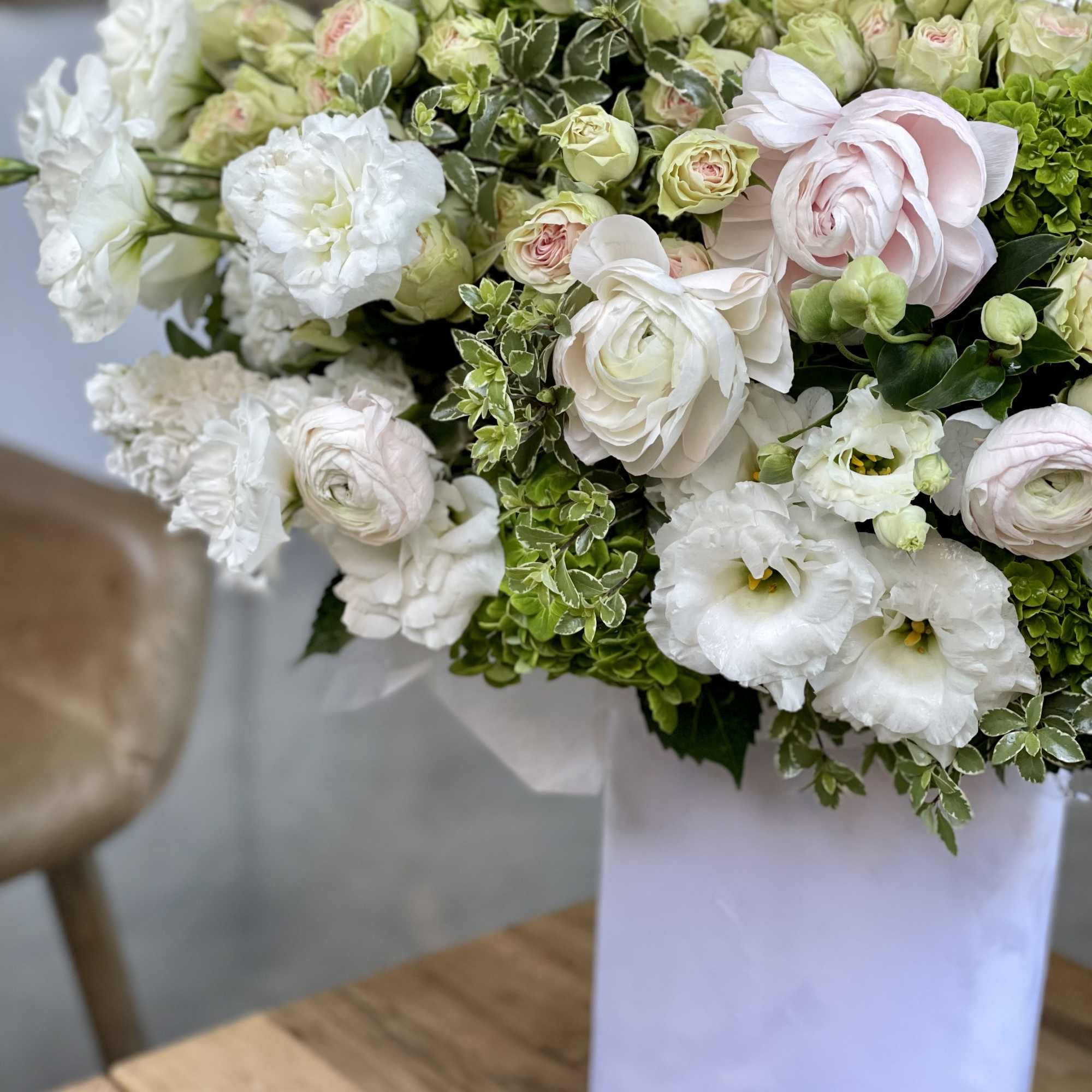 White and pale pink flowers arranged in a white vase, photo 9 of 12