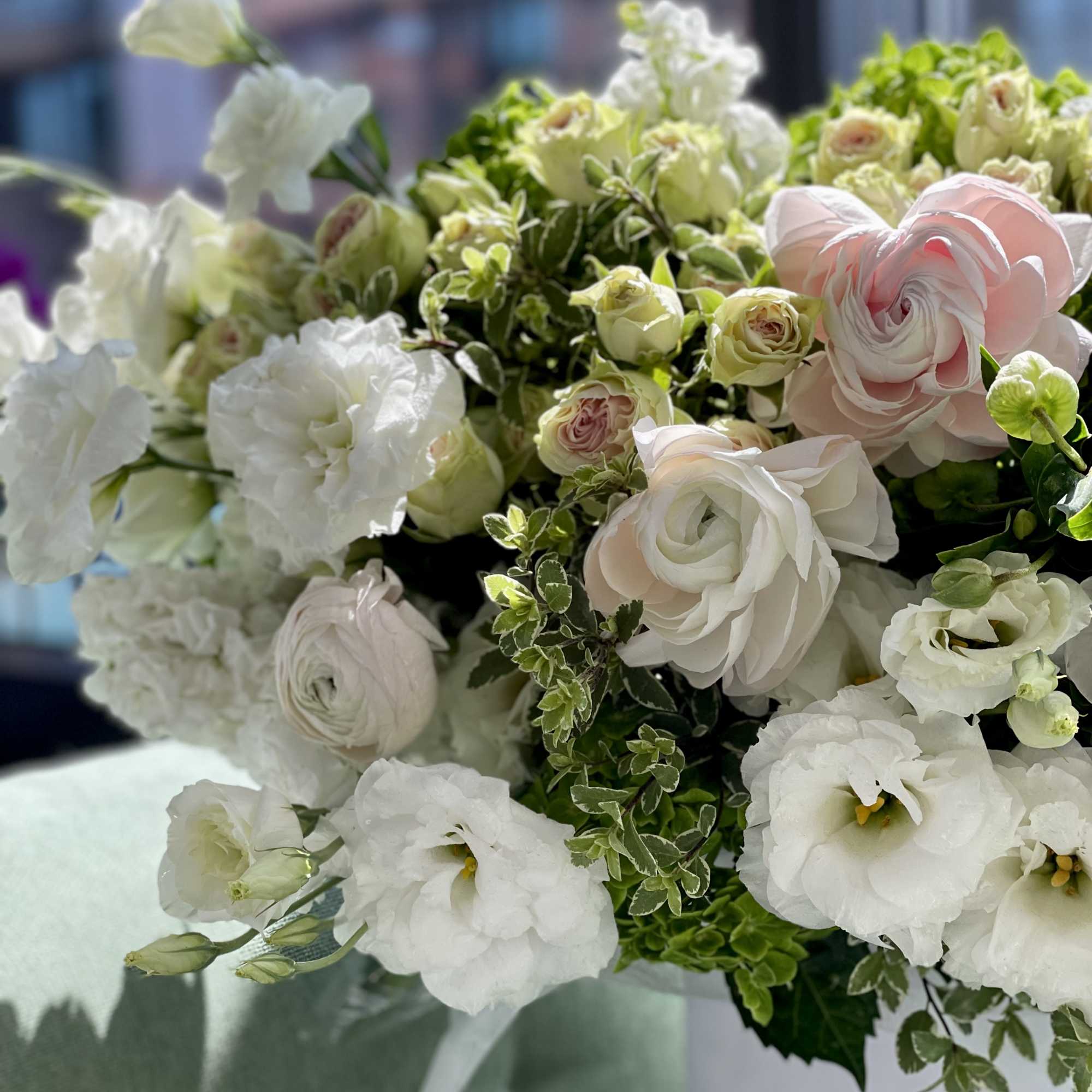 White and pale pink bouquet with roses and lisianthus