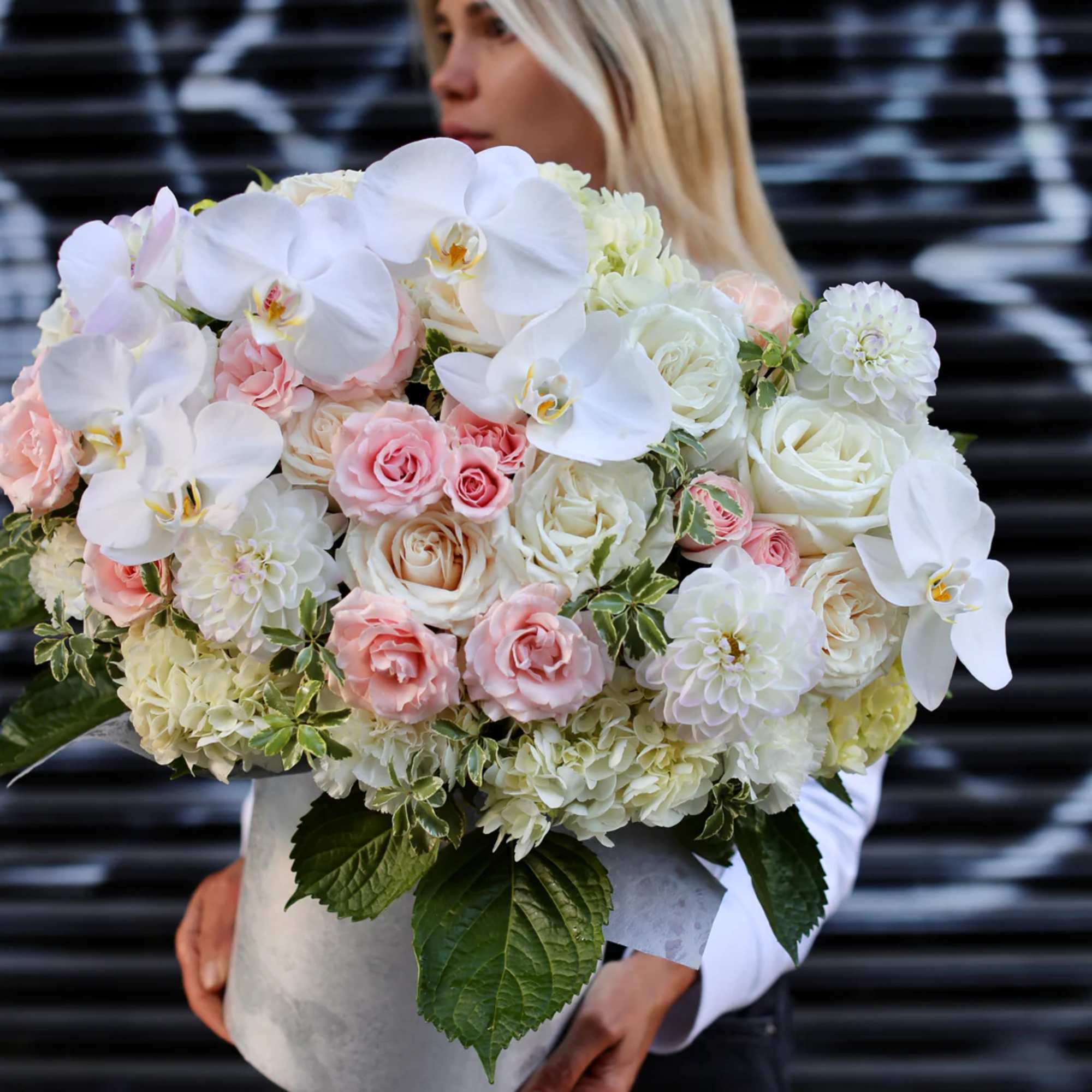 Large bouquet of white orchids, roses, and pale pink blooms