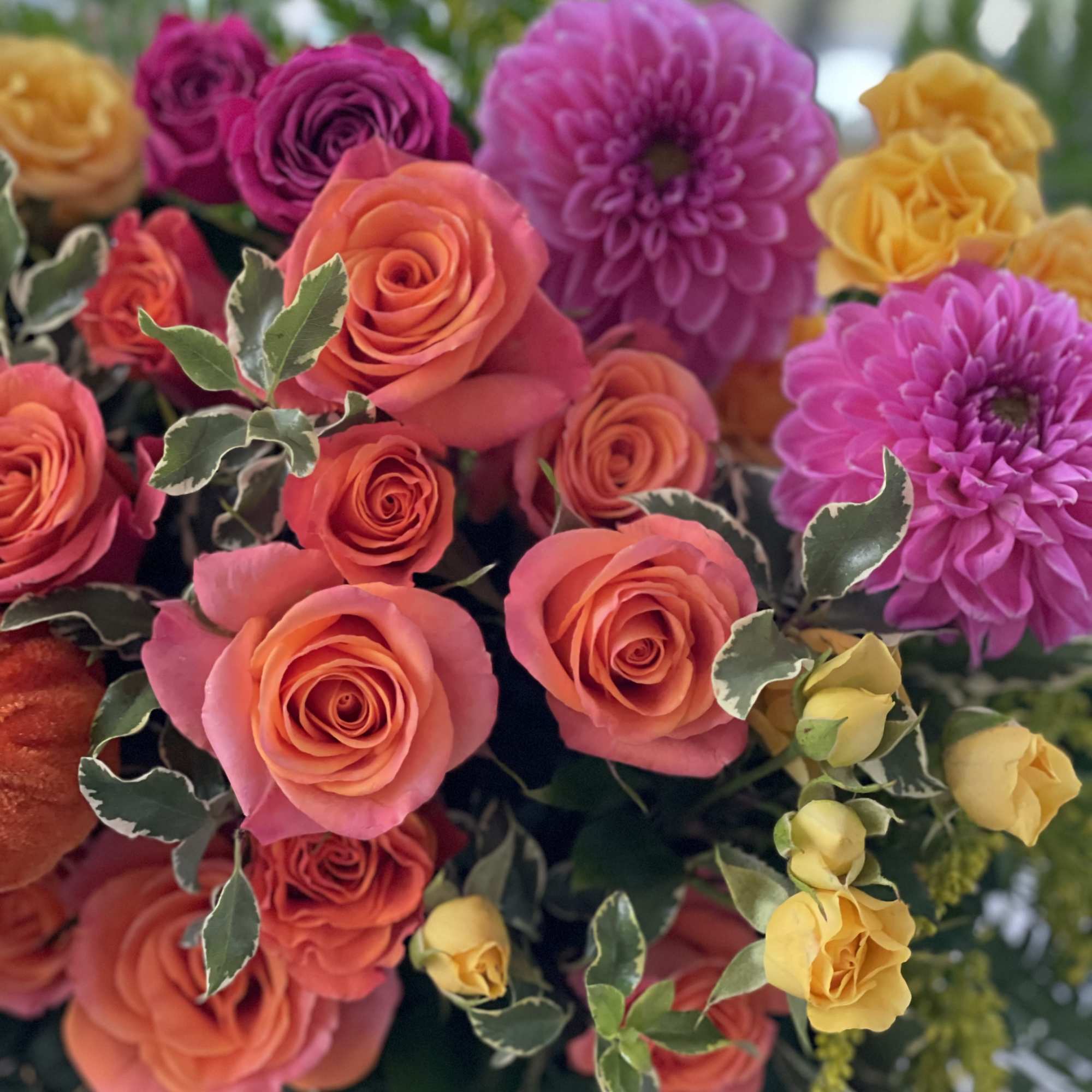 Bright mixed bouquet with roses and purple blooms