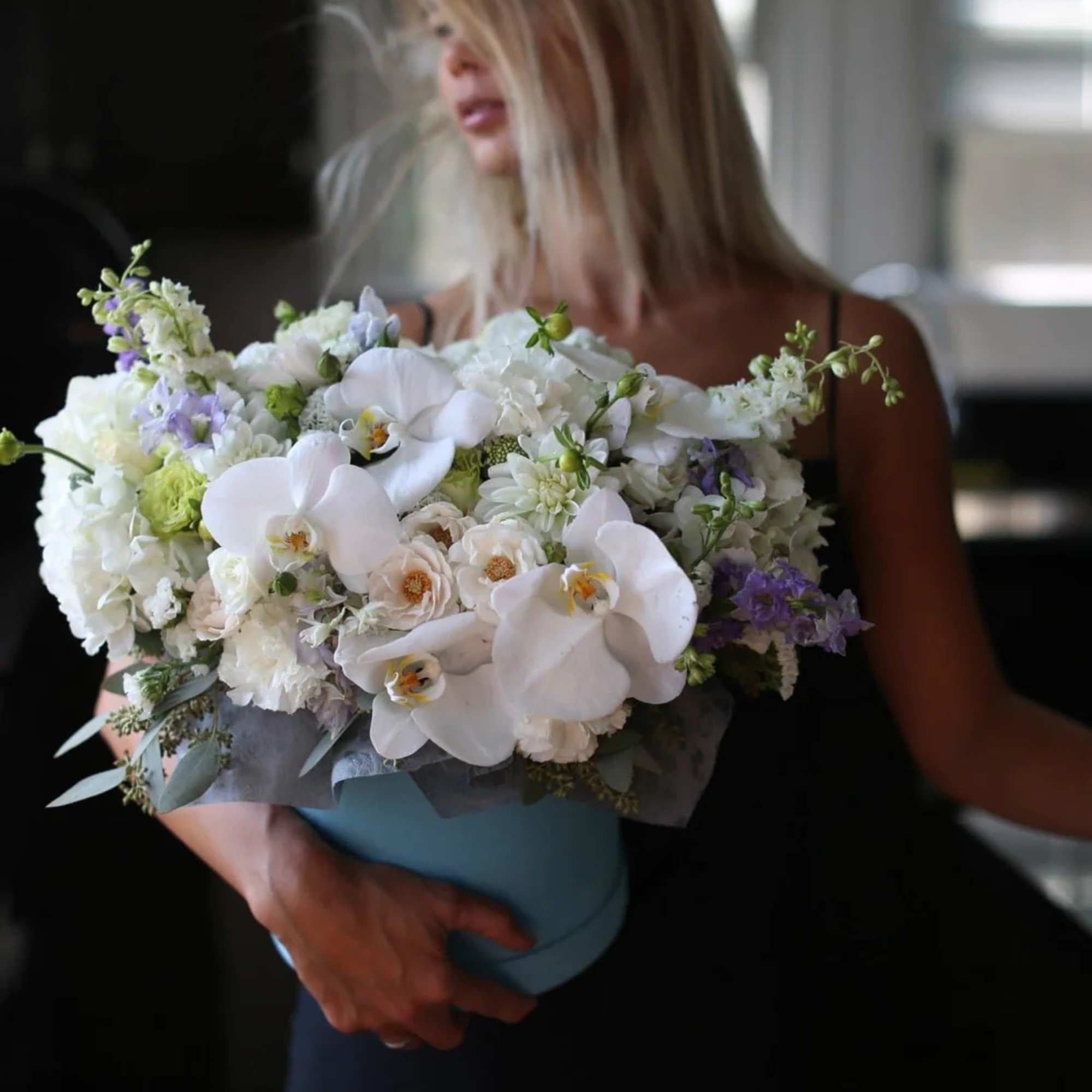 Large bouquet of white orchids and mixed pastel flowers