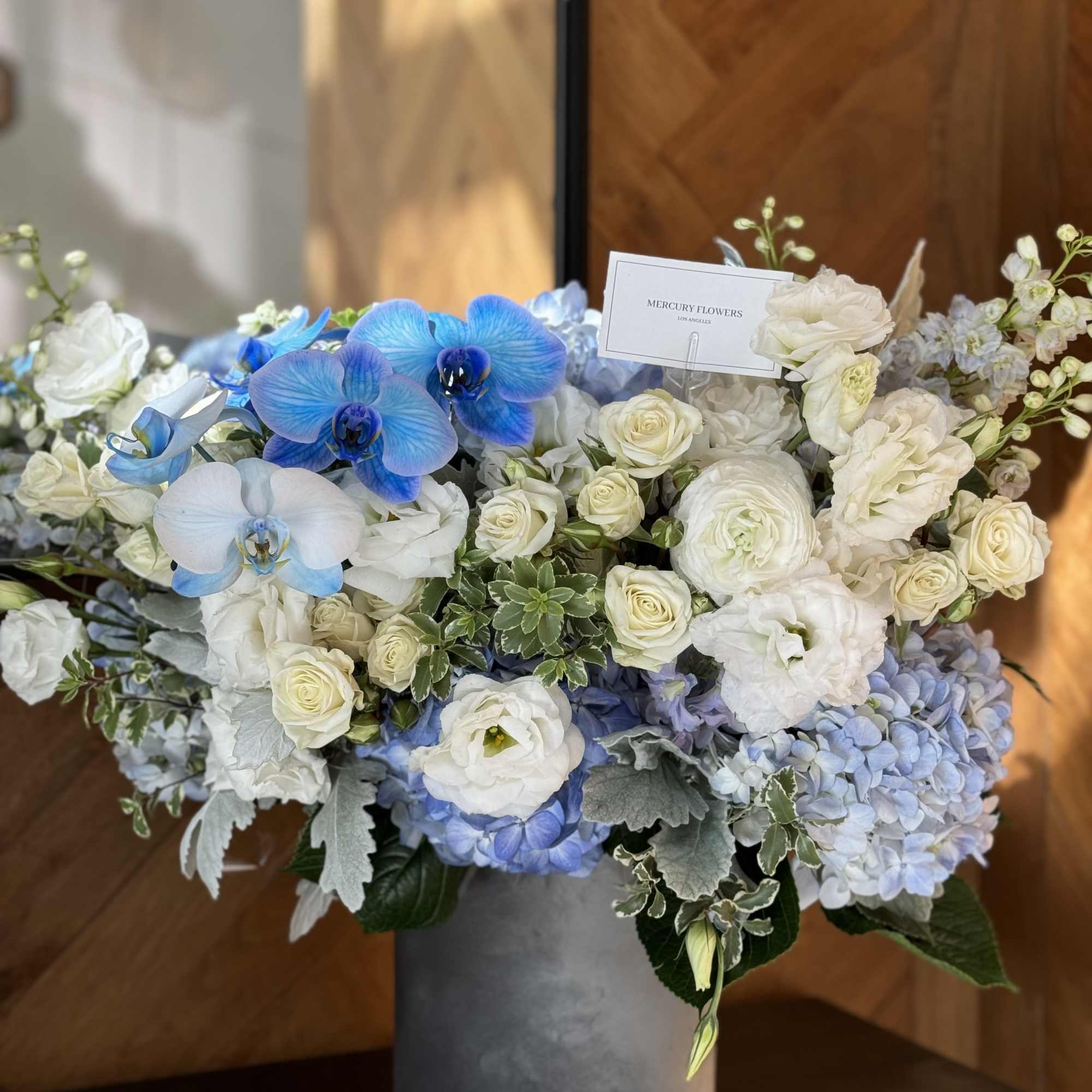 Blue and white floral arrangement in a gray vase, photo 4 of 7