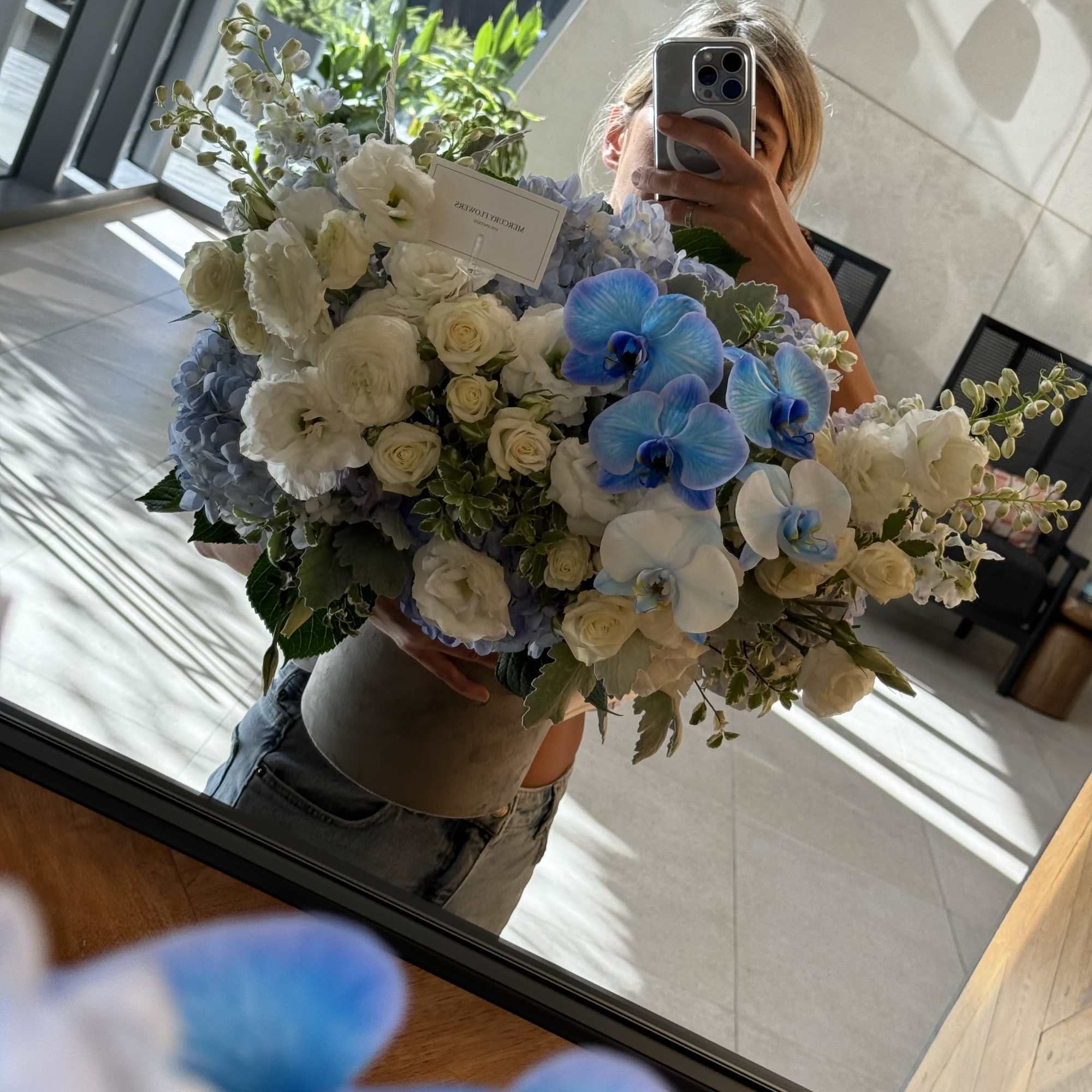 Large bouquet of white roses, blue hydrangeas, and blue orchids