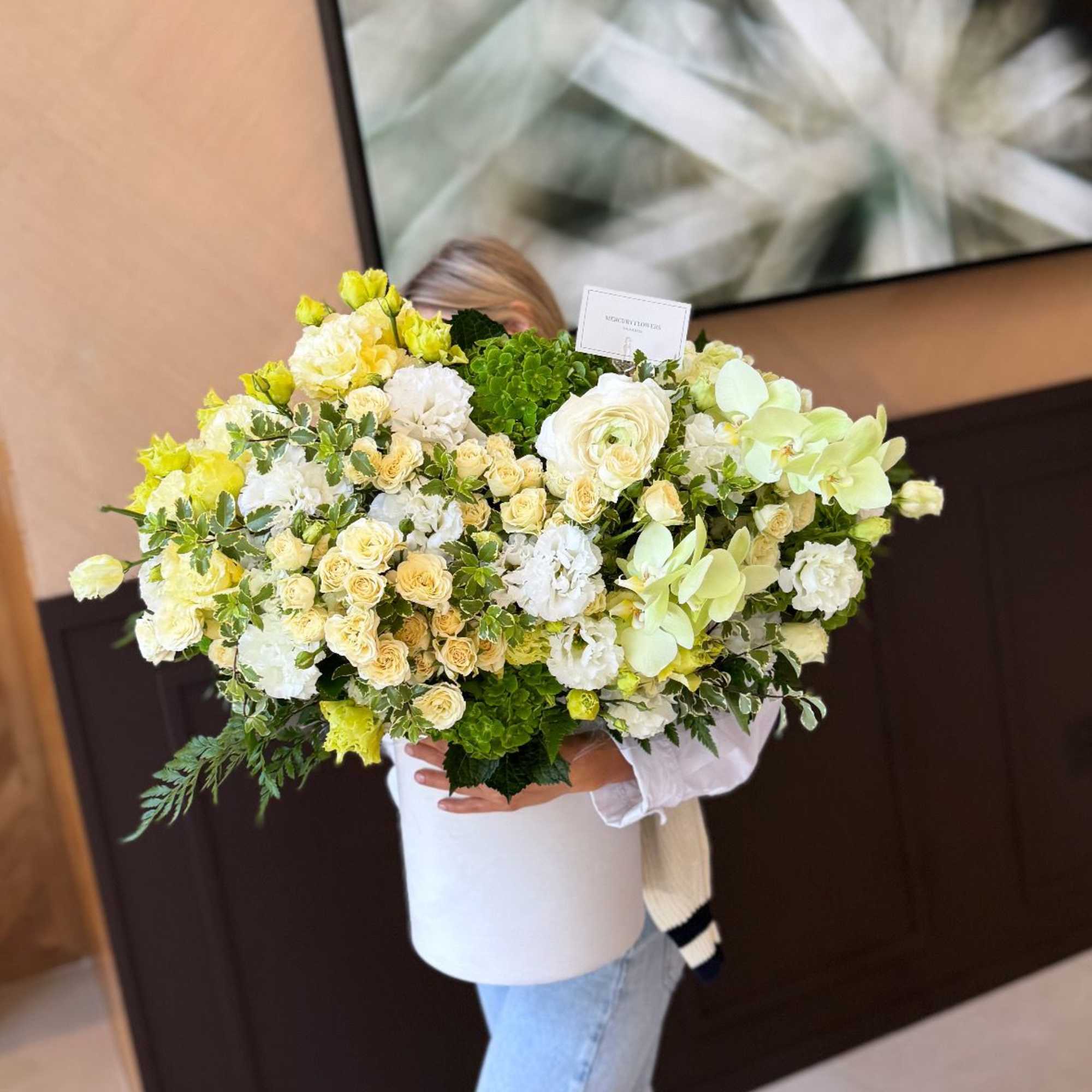 Large bouquet of white and pale yellow flowers in a white box