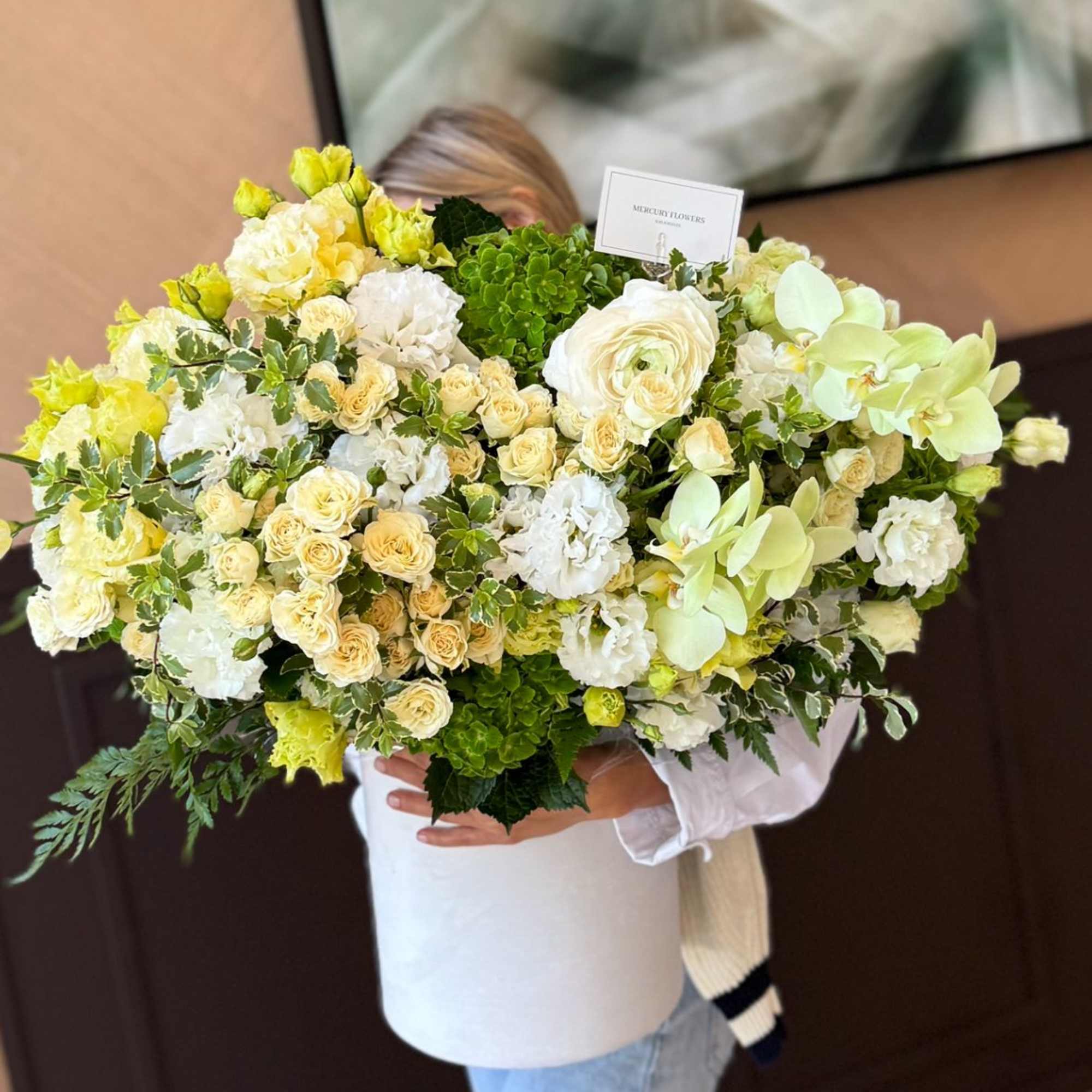 Large bouquet of white, cream, and pale green flowers