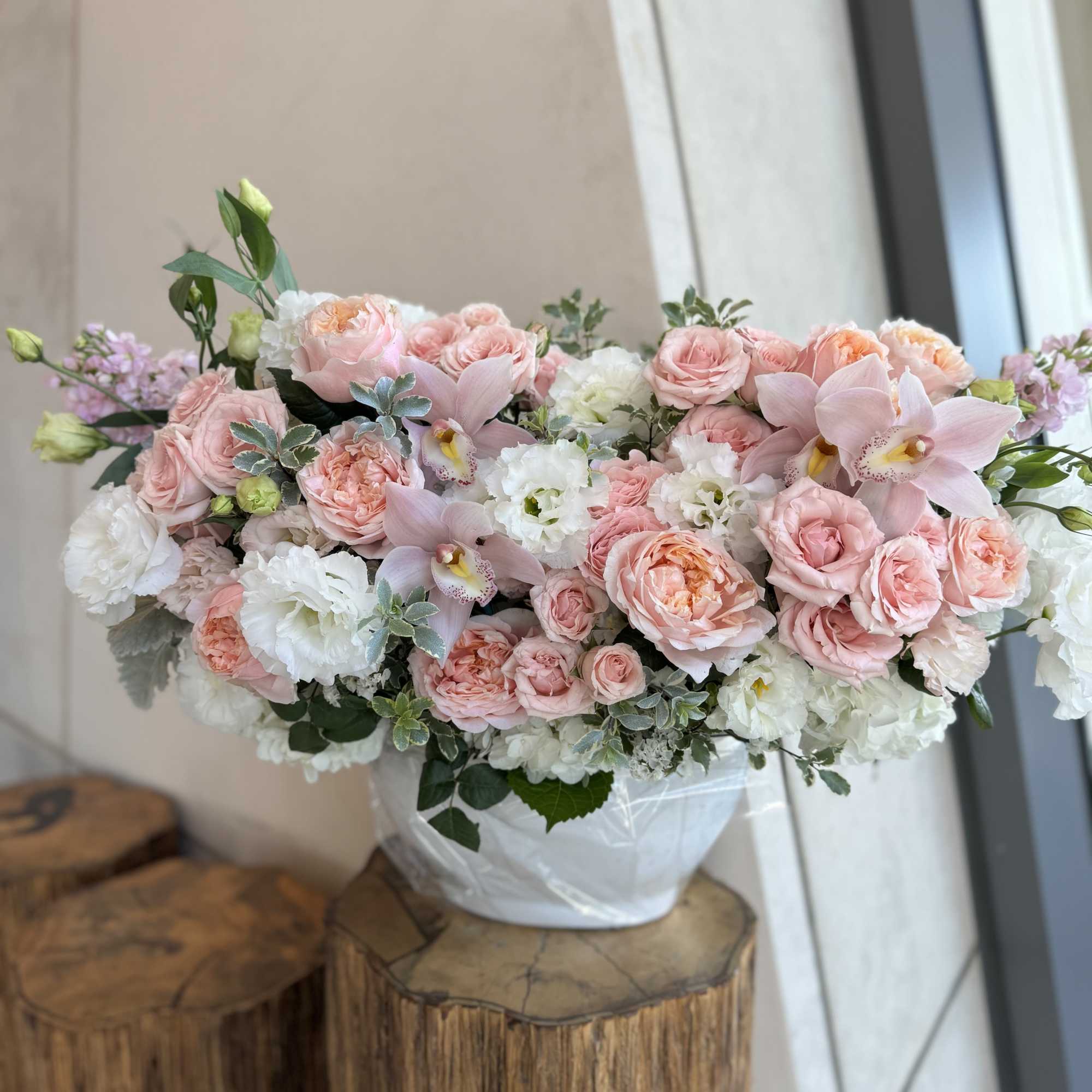 Pink and white floral arrangement in a white vase