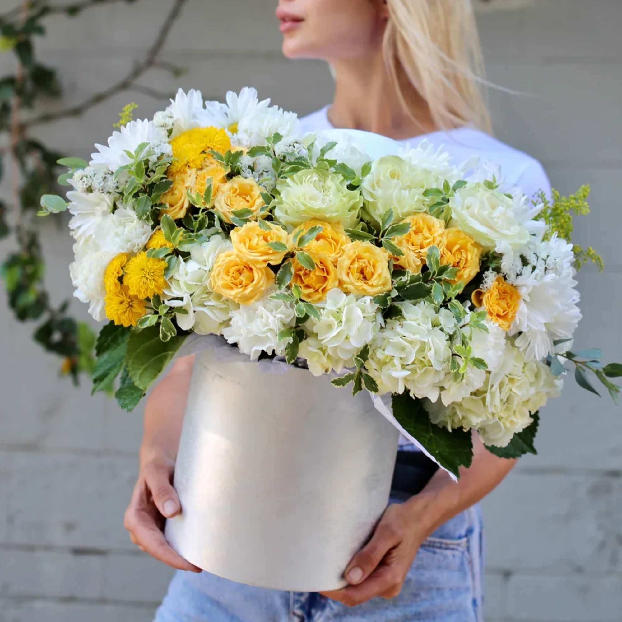 Large bouquet of white and yellow flowers in a white box