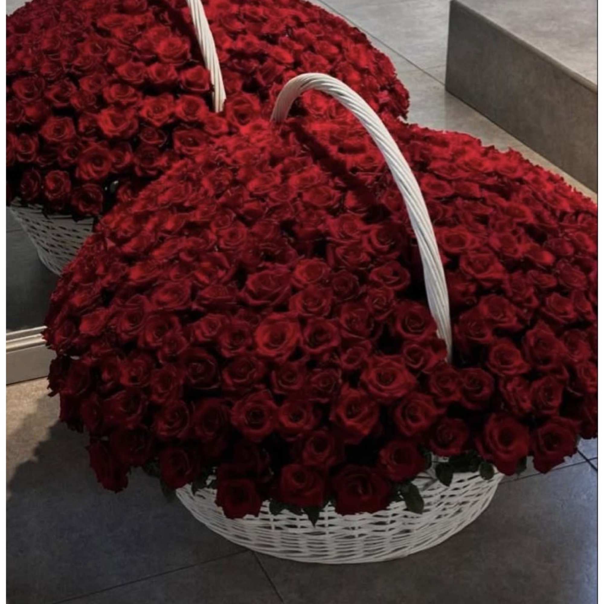 Two large baskets filled with red roses