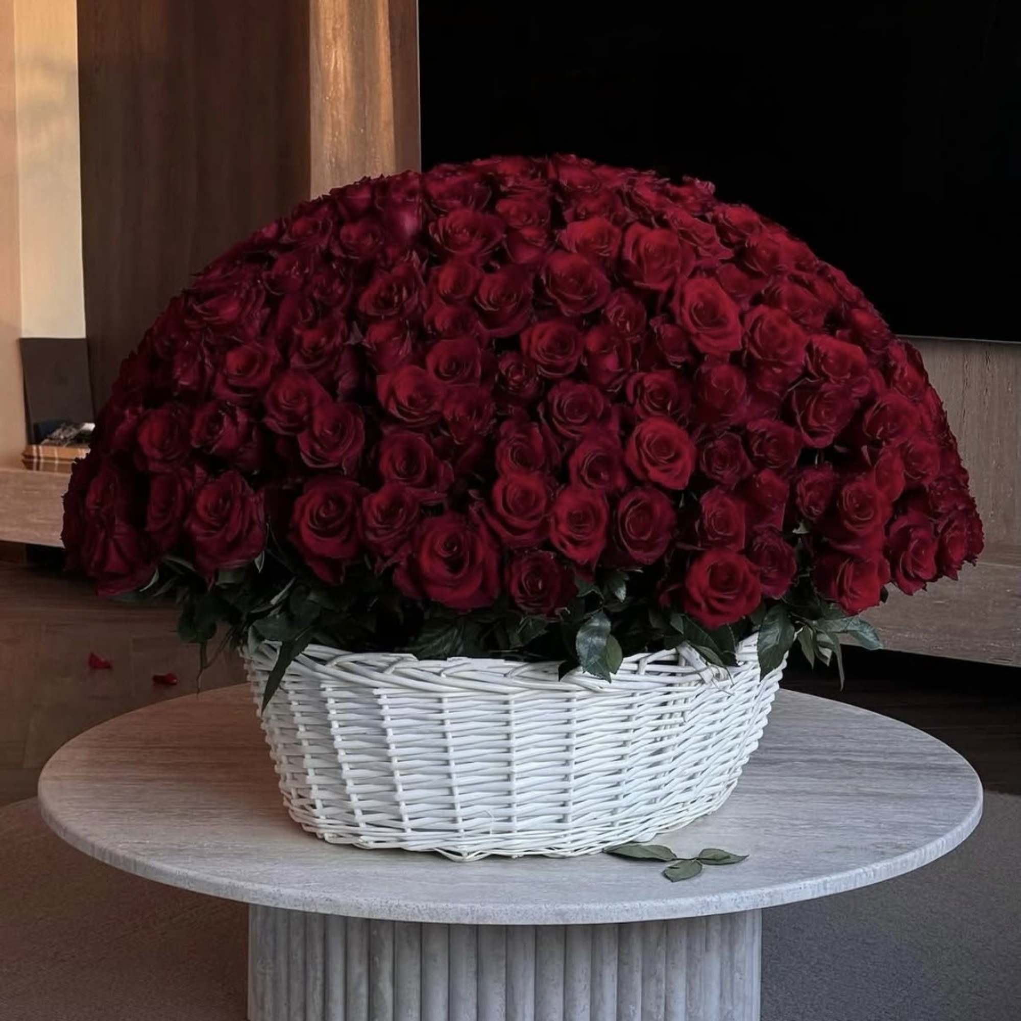 Large dome of red roses in a white wicker basket