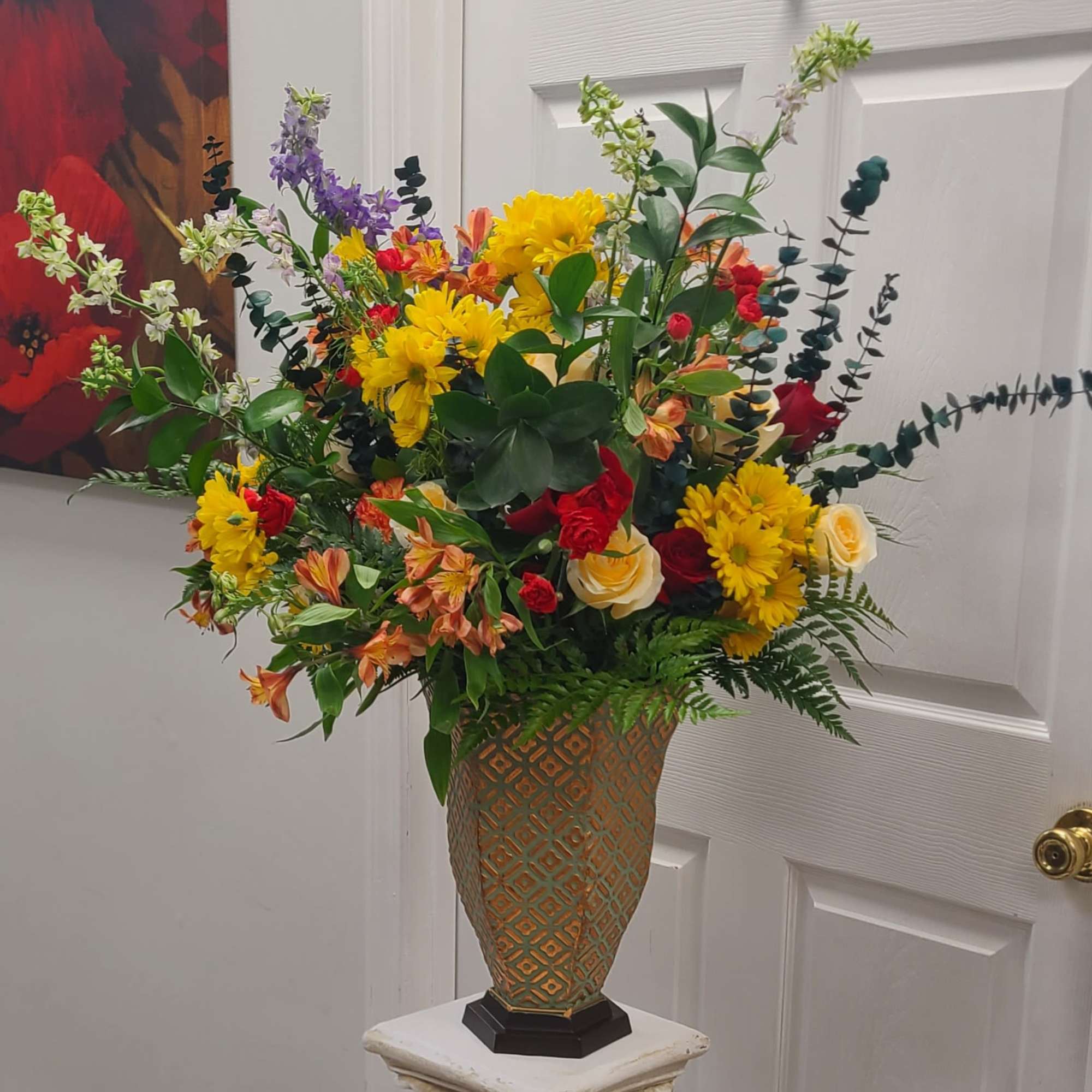 A towering, celebratory mixed flower arrangement built to catch the eye -
