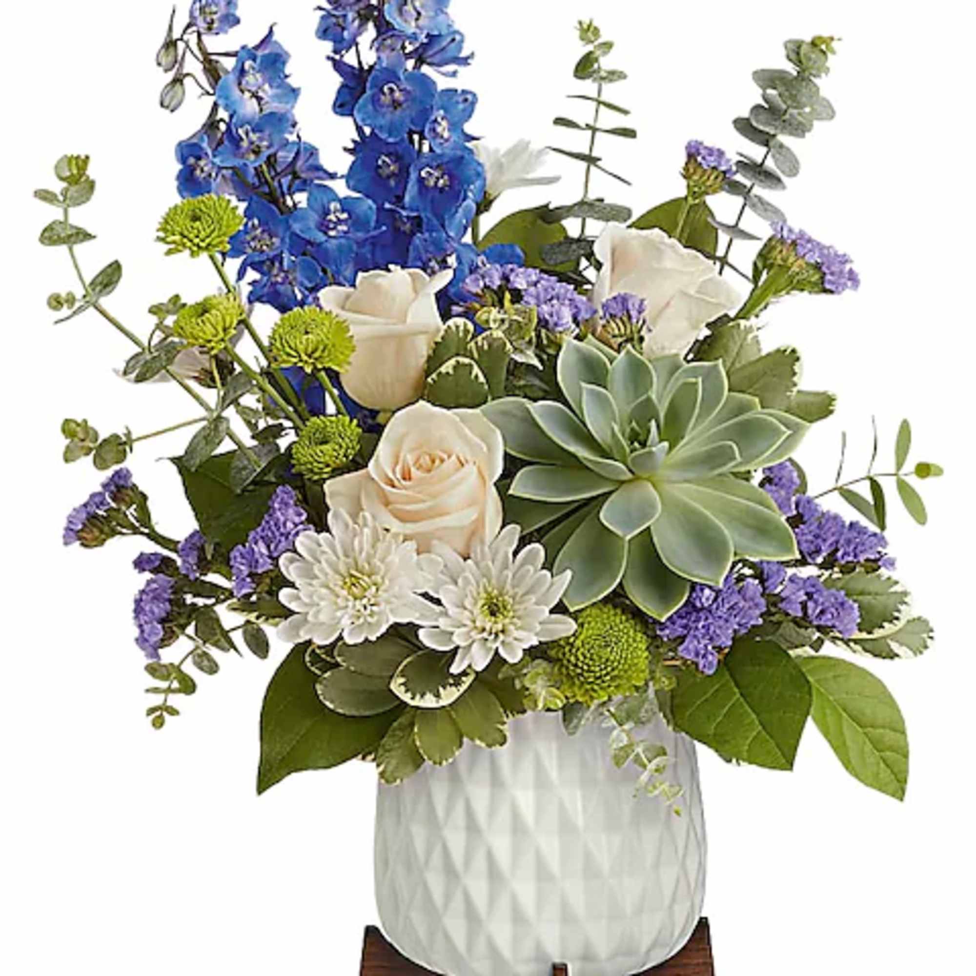 Blue and white floral arrangement in a white vase with a succulent