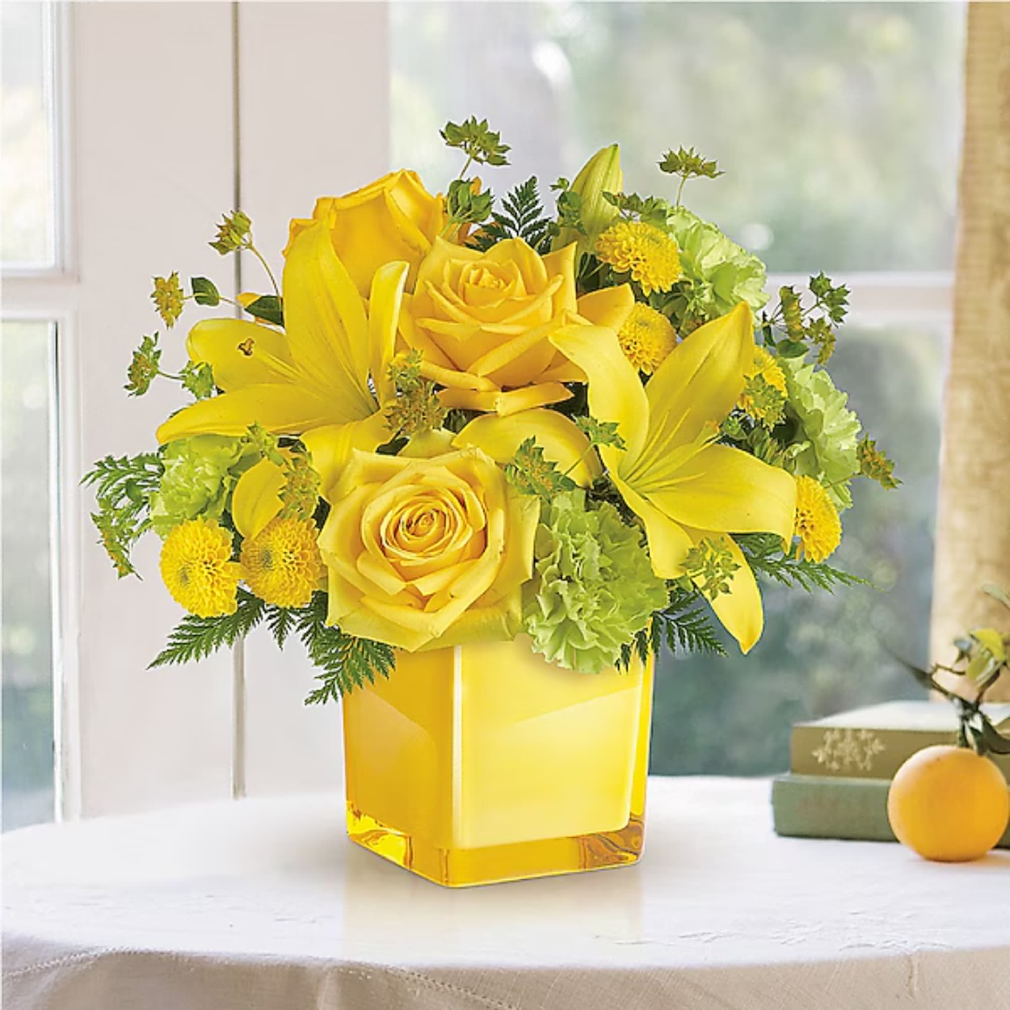 Yellow roses and lilies arranged in a square glass vase, photo 2 of 2