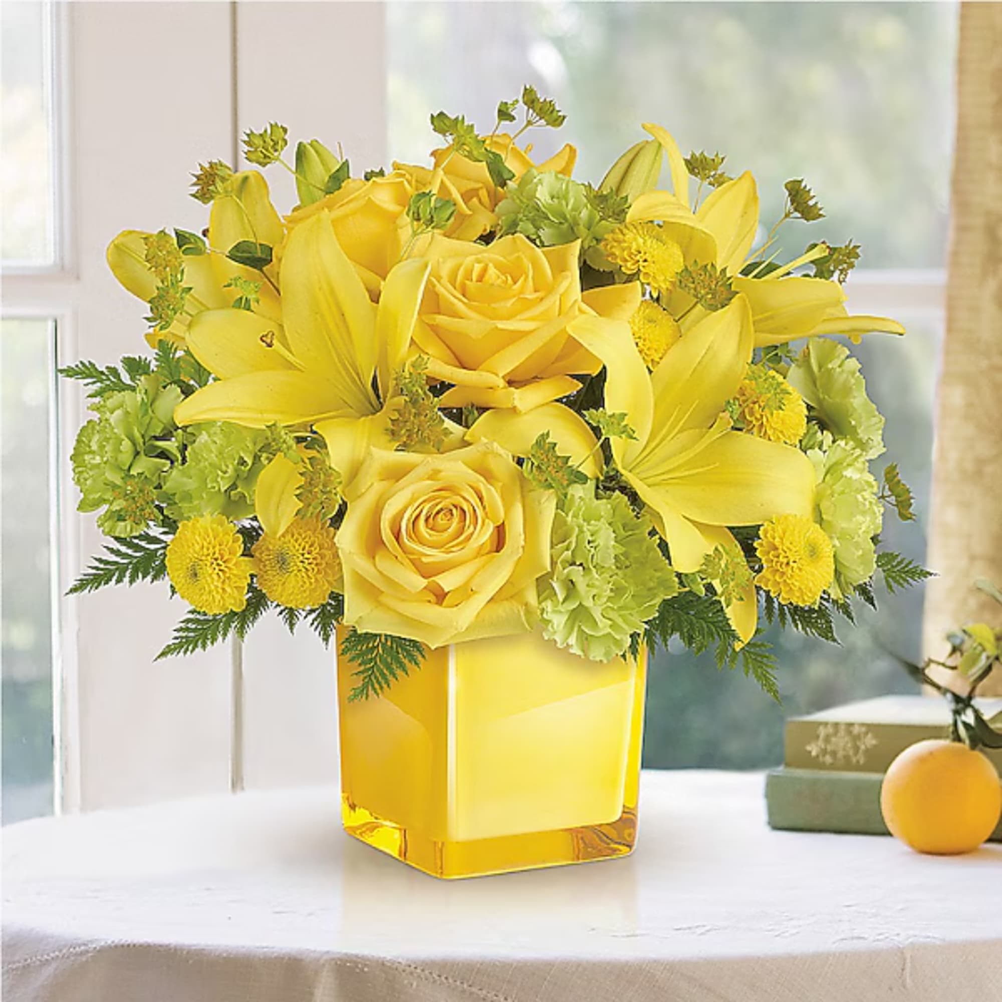 Yellow roses and lilies arranged in a square glass vase, photo 2 of 2