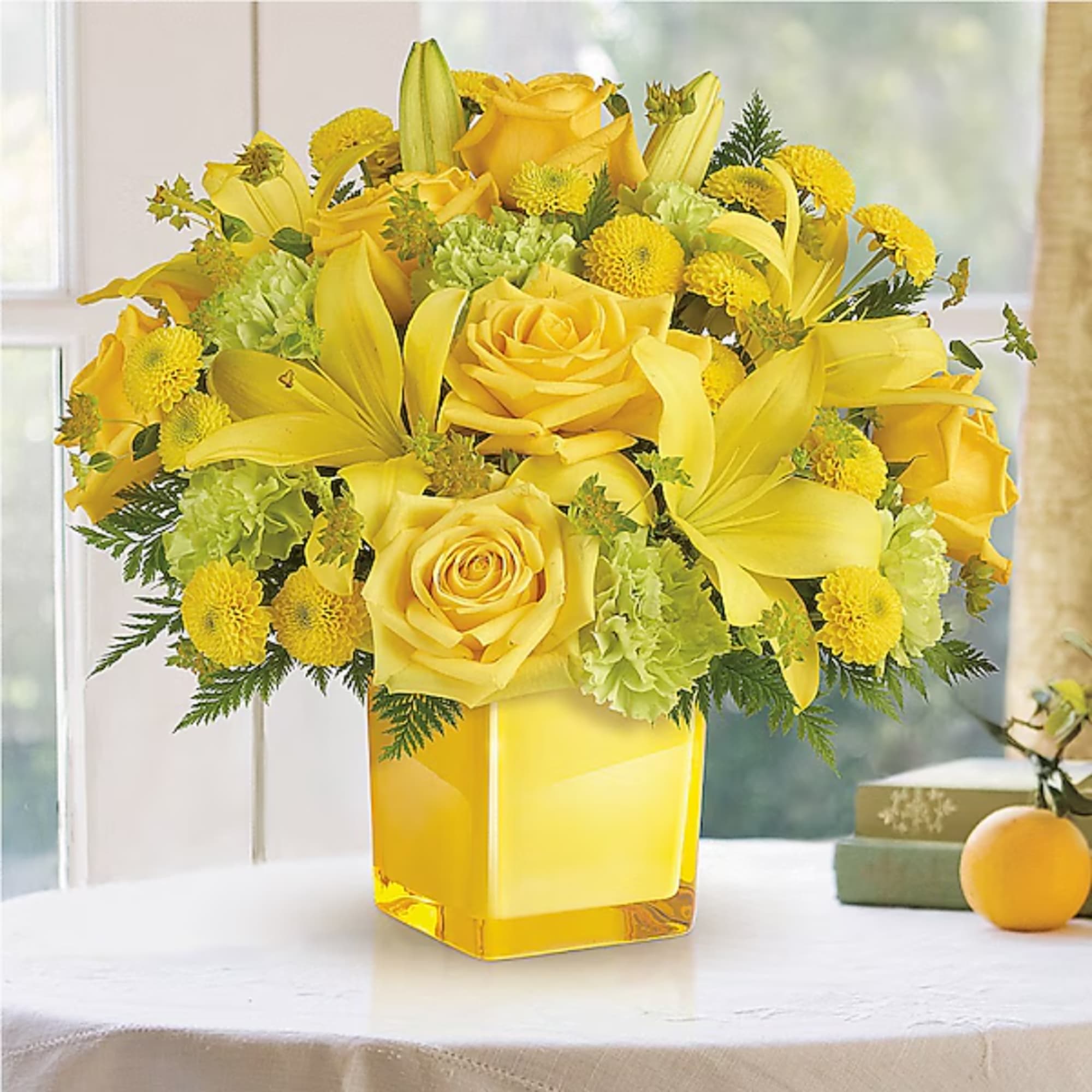 Yellow roses and lilies arranged in a square glass vase, photo 2 of 2