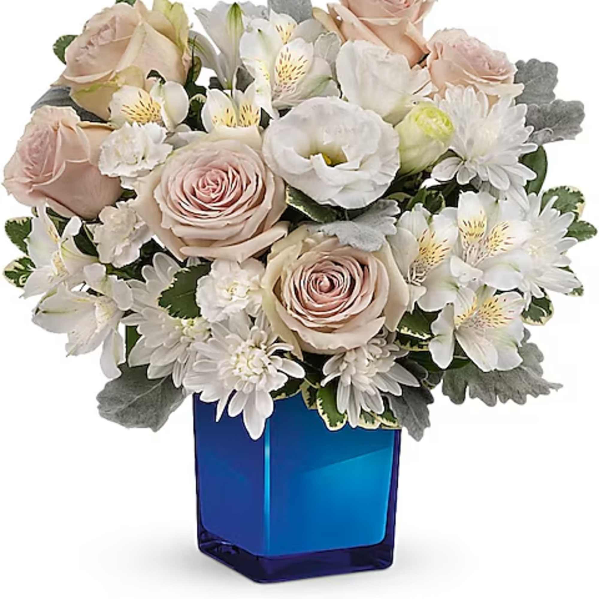 Blush roses and white mixed flowers in a blue glass vase