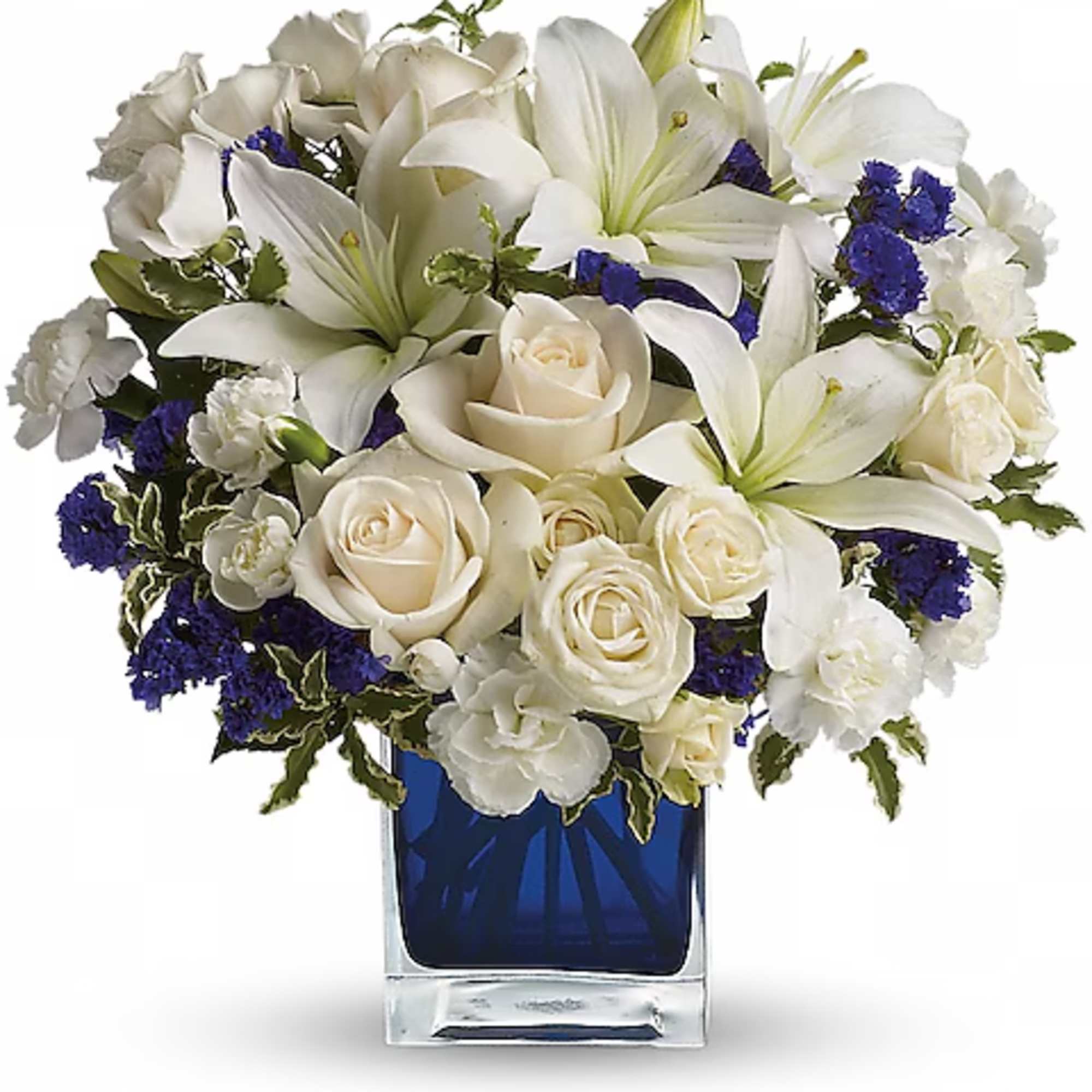 White lilies and roses arranged in a blue glass vase