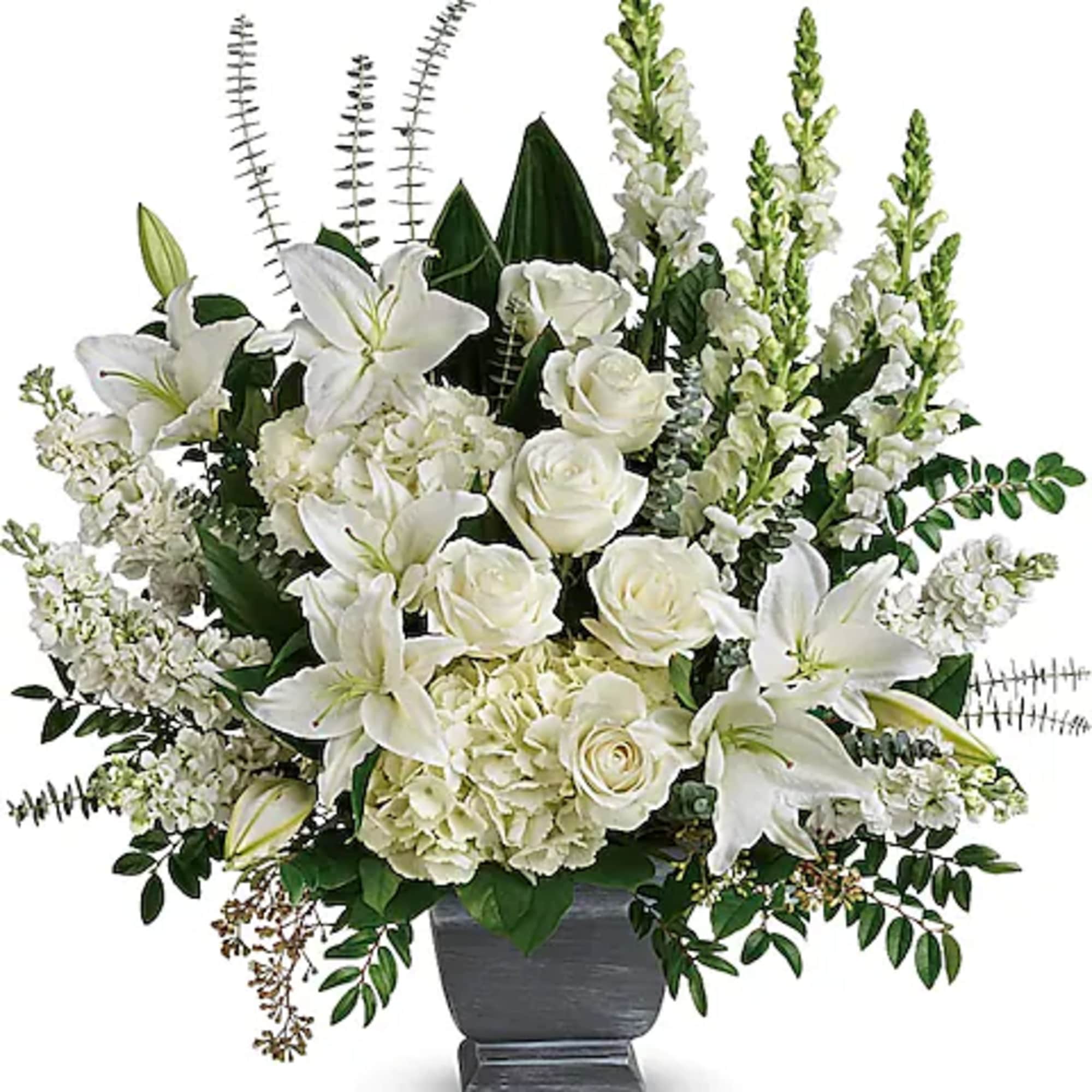 White lilies and roses arranged in a dark vase