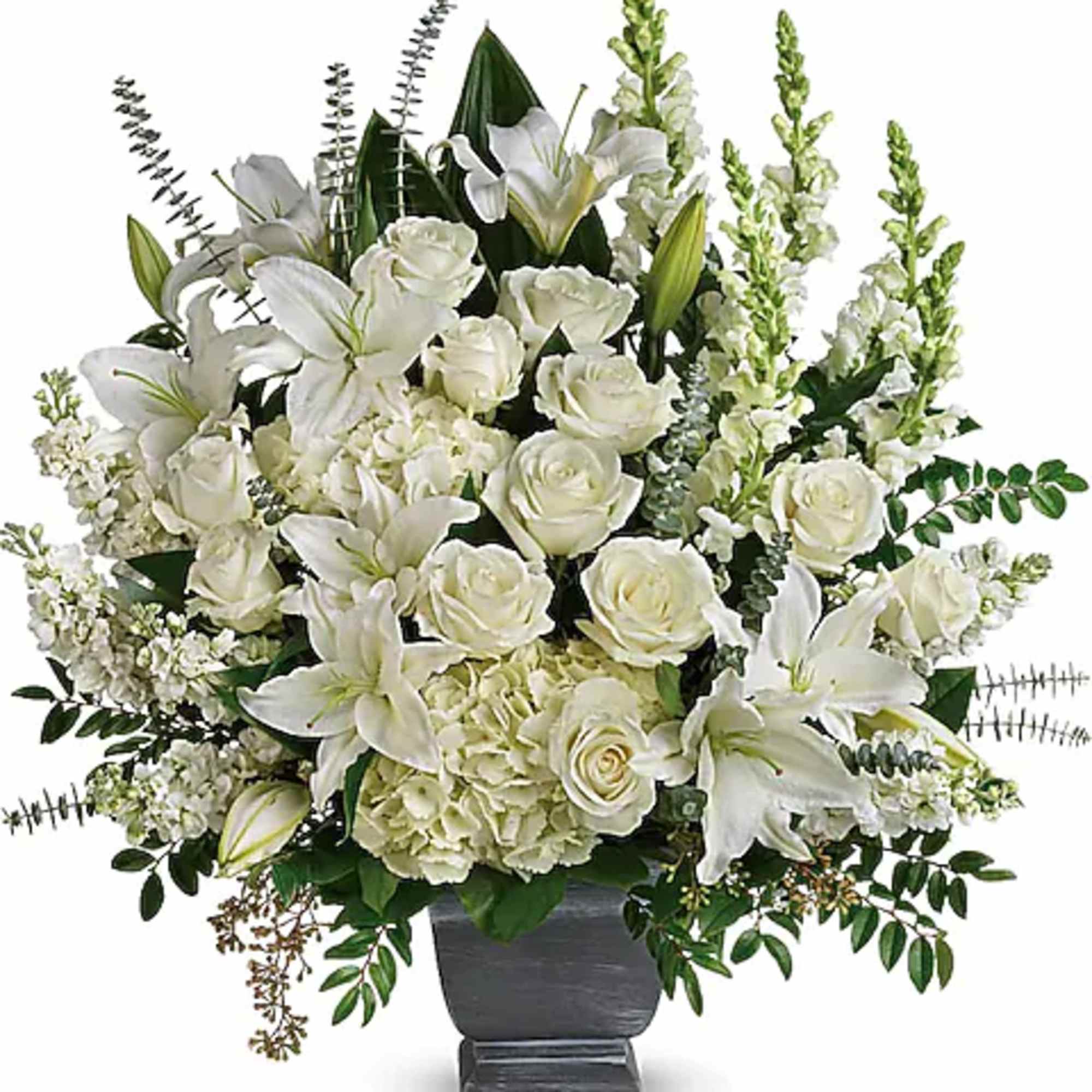 White lilies and roses arranged in a dark vase