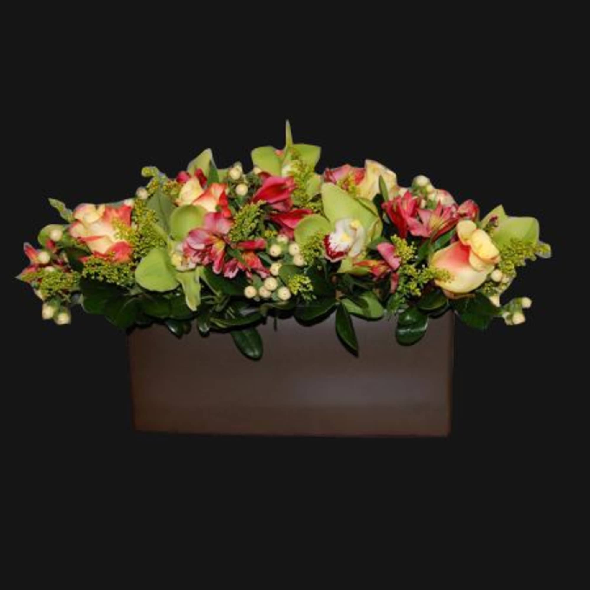 Mixed floral arrangement in a rectangular box with pink and cream blooms