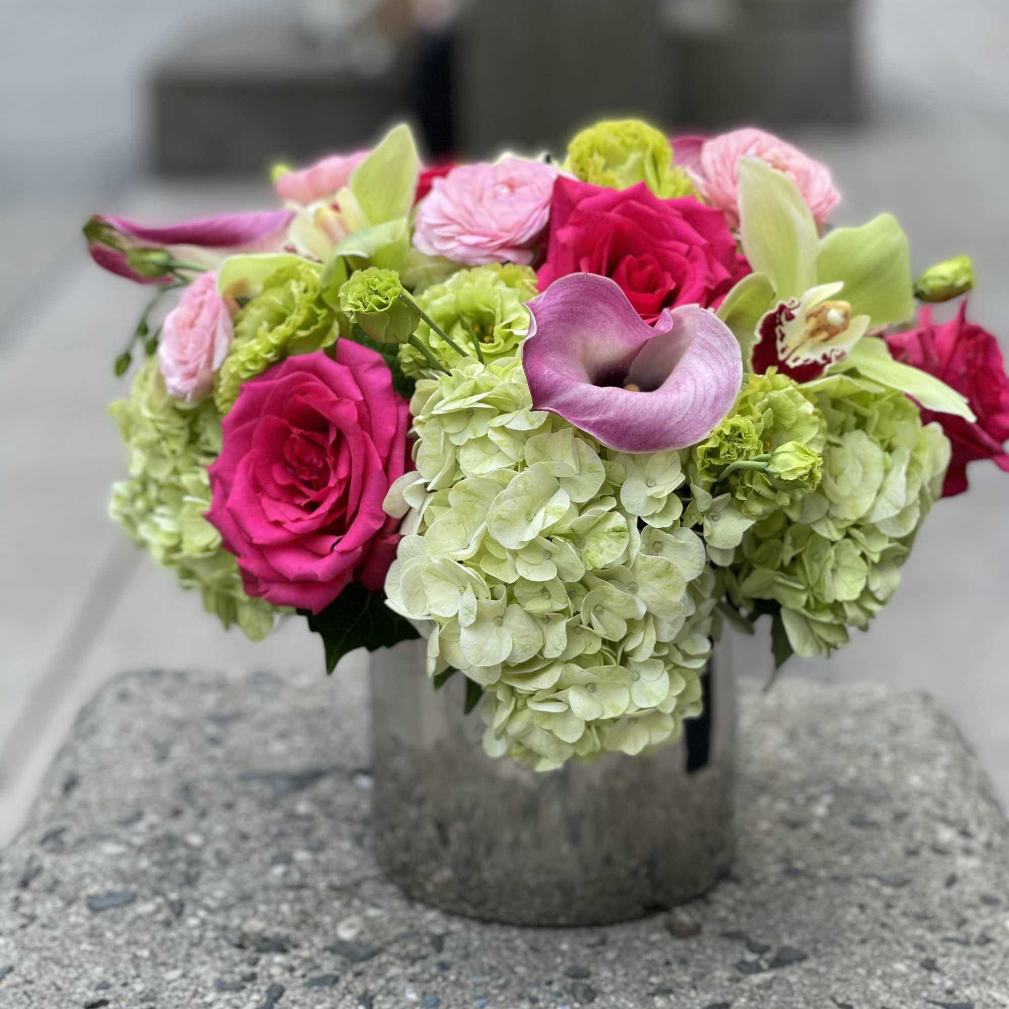 Pink roses and green hydrangeas in a metal vase