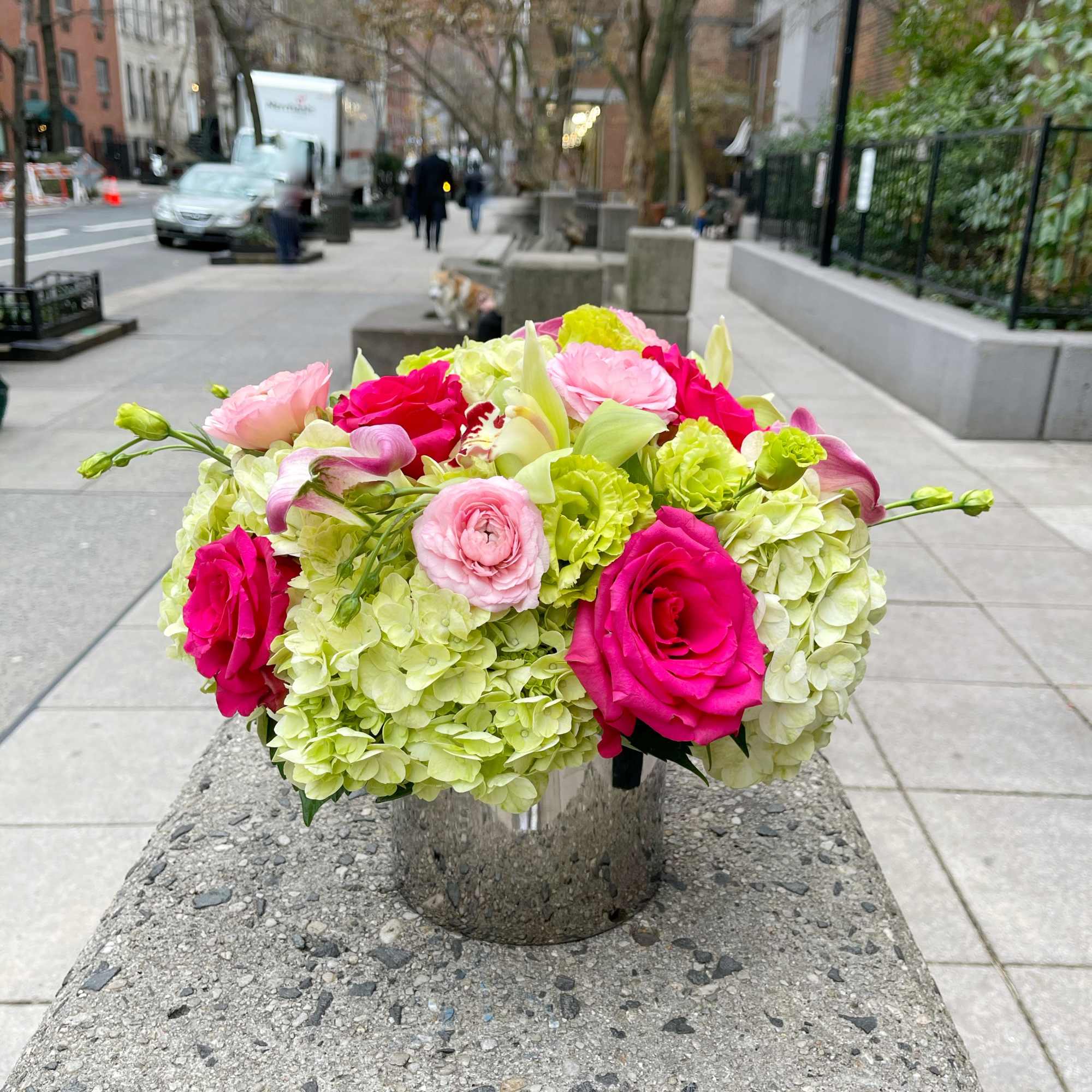Pink roses and pale green hydrangeas in a metal vase